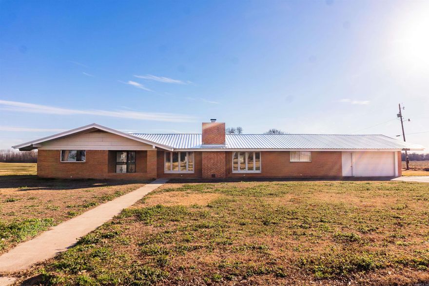 This isn’t just a house—it’s a lifestyle opportunity. Situated on nearly an acre in Lonoke County, this property sits in the heart of some of the most popular and productive duck hunting areas in the world, surrounded by premier waterfowl habitat. Whether you’re looking for a peaceful family homestead or the perfect duck hunting lodge, this home offers the space and flexibility to make it your own. The open-concept layout is ideal for gatherings with family or hosting hunting buddies after a day in the blind. A massive kitchen is built to serve a crowd, and durable terrazzo flooring in high-traffic areas stands up to boots, gear, and everyday life. Enjoy quiet mornings and relaxing evenings on the large screened-in porch overlooking the countryside. Recent updates include a metal roof, water heater, HVAC split system, and new dishwasher.