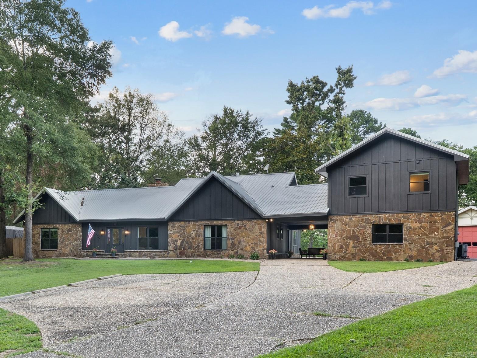 A SPACIOUS HOME with 3093 sq ft., a GUEST HOUSE with 1510 sq ft, AND a SHOP with 800 sq. ft. all on 2.6 ACRES in West Conway! WOW! The main home has so much personality with 3 beds, 3 full baths (two full of vintage flair & one ready for your personal touch), an office, and TWO living spaces! You’ll love details like the pit-style living room, floor-to-ceiling stone fireplace, & an indoor planter that brings a little nature inside. Need even more space? Walk across the charming portico to find the detached 2-bedroom, 1-bath guest house with laundry area & a big open living area with kitchenette hook ups! The big stuff has already been done with this property- over $230K in updates, including new Hardie board siding, Marvin windows, ext doors, lighting, electrical, plumbing, energy-efficient upgrades, city sewer tie-in, privacy fencing & all new electrical panels. Outside there are mature trees, tons of green space, & so much space to simply enjoy. Let's be real, places like this DO NOT come around often! A few finishing touches are still waiting, giving you the chance to add your style & make it truly yours. Call today!***AGENTS SEE REMARKS