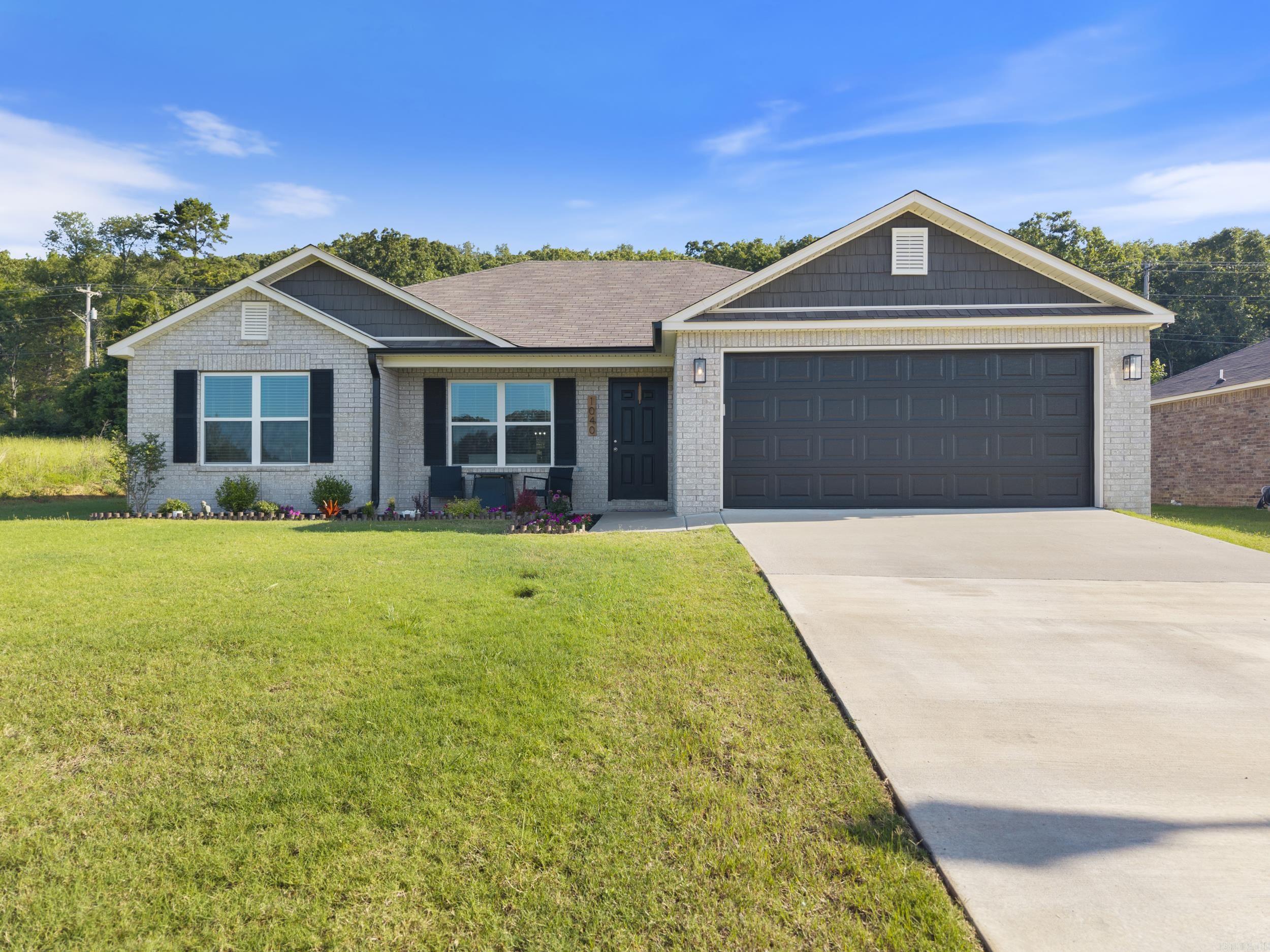 Conway Corp Utilities! The lovely RC Clark plan is rich with curb appeal with its welcoming front porch and front yard landscaping. This home features an open floor plan with 3 bedrooms, 2 bathrooms, and a large living room. Also enjoy an open dining area, and a charming kitchen fully equipped with energy-efficient appliances, generous counter space. Home is in pristine condition. Buit in shelving in the garage. Several upgrades in the home: soaking tub/shower and double sinks in the primary bathroom, cabinets in the laundry room, 50 gallon water heater, deep kitchen sink, living room and bedrooms are wired for a ceiling fan, extra disc lighting throughout, and crown molding on the kitchen cabinets.