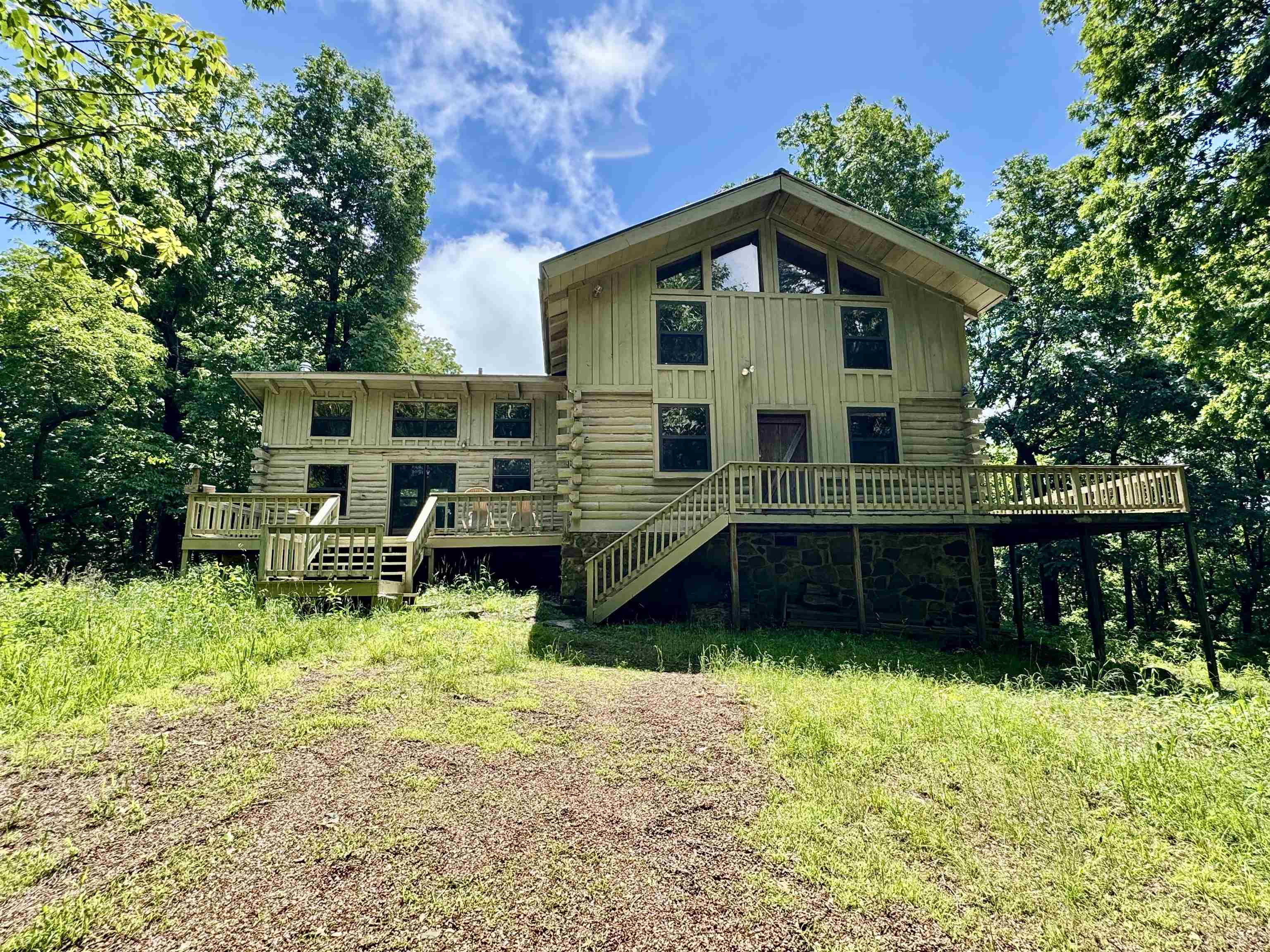 Wow is all I can think of with this beauty. If you want a true piece of Arkansas's majestic forests, then this is the place for you. Eighty-six acres of private natural beauty. Hiking trails thru out. Seasonal waterfall and creek. It even has a natural spring on the property line. The cabin is two Bedroom, two bath. Master bedroom and bath is on the main floor with 360-degree views. And it has its own deck to enjoy the wildlife. Open floor plan on the main floor with a wood burning fireplace. The Ozark Mountain views off the side deck are amazing. The upstairs loft area has a second bedroom and other room that could be a third bedroom. This gorgeous place would make a great vacation get away or even a full-time home. The location is perfect 5 miles from the White River. Just a short scenic drive to Melbourne or Mountain View. I can't say enough about this beautiful place. It's a must see