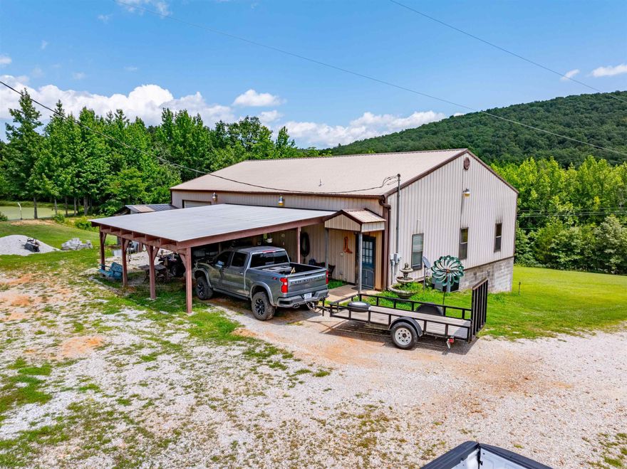 Welcome to the market! A beautiful shop house,1800 sq ft home nestled in the Ozarks with vista views of the hills across and behind the property.  The home has 2 bedroom, 2 bath with an additional room that could be utilized a bedroom, beautiful tile & vinyl flooring throughout for easy cleaning. Extra large laundry room with lots of storage,  The main bedroom has its own bathroom with air-jetted tub with shower, double vanity and huge walk-in closet. High ceilings in the living room with lovely stained wood make it feel warm and inviting. The cute kitchen is well designed has a natural rock accent wall that really makes it pop and the pretty countertops sit atop custom made solid oak cabinets, there is also a custom made solid oak pantry all stained in a beautiful rich brown stain. There is a one car carport, also a one car garage with extra storage and a lean-to shed attached for even more storage. This beautiful 4.37 +/- acres has approximately 540 ft of highway 9 frontage and is partially wooded and has a large stocked pond, creek, and walking trail through the woods also small chicken coop that will remain. This propety is fenced on 3 sides.
