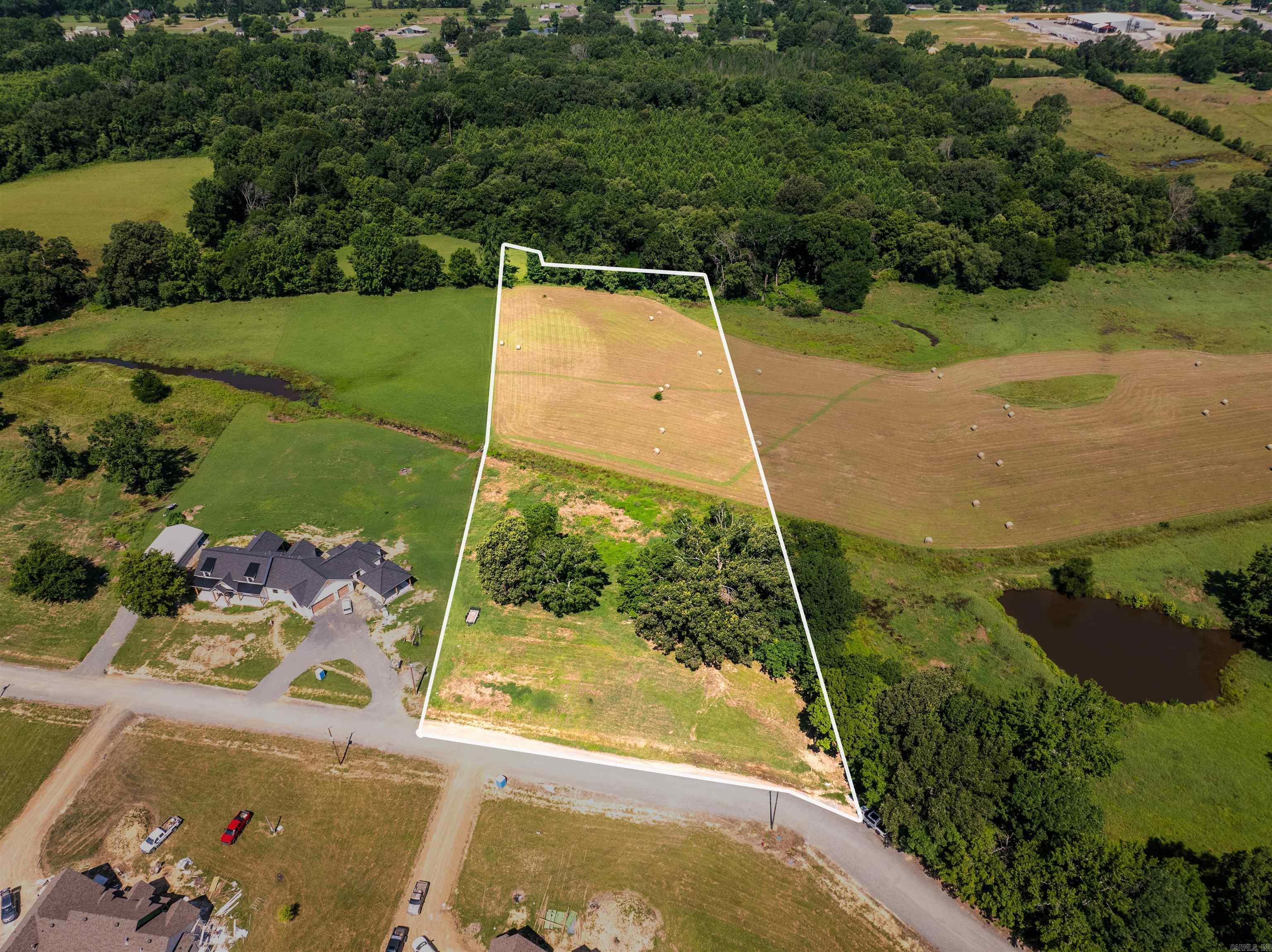 Lot 3. Nestled along Justice Farm Road in Conway, this 5± acre property presents a rare chance to own land in one of the area’s newest residential developments. Surrounded by custom homes, the setting is well-suited for a primary residence, offering flexibility, privacy, and an attractive location.