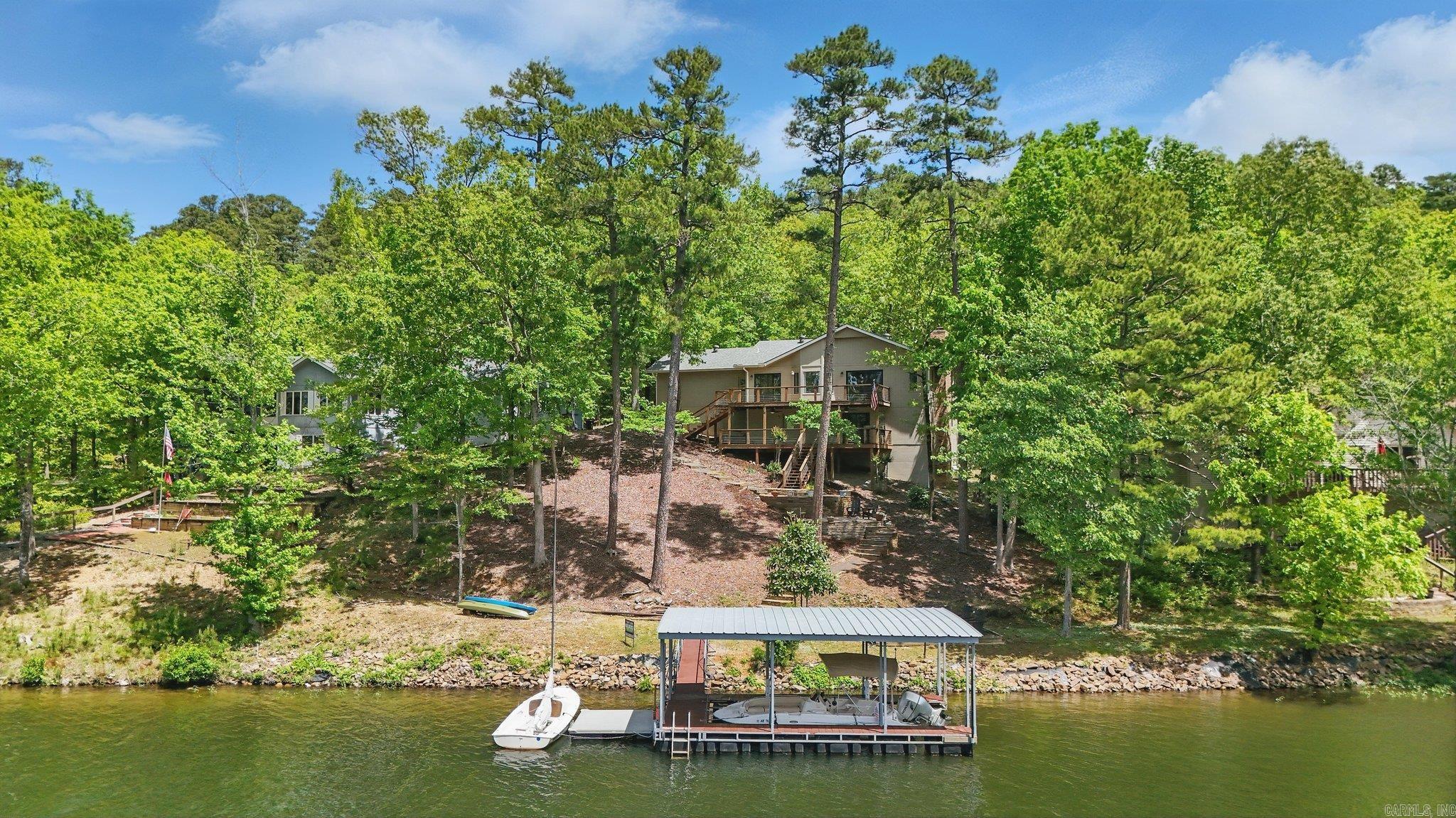 Easy Lake Living on Lake Cortez! This awesome 3-bedroom, 3-bath home sits right on the shore of Lake Cortez and brings all the lake life vibes! Inside, youāve got a bright, open layout that flows out to a big deckāperfect for morning coffee or grilling with a view. The backyard is seriously impressive with amazing, tiered landscaping that leads down to your very own covered boat dock. Need space for guests, man cave or looking for rental potential? The lower level has a complete studio apartment with a kitchenette, full bath, lower deck and private entrance. Generator with buried propane tank, sliding glass doors replaced, newer roof and water heater, HVAC 2019. Whether youāre into kayaking, fishing, or just soaking up the sun, this place makes it easy to live the lake life every day.