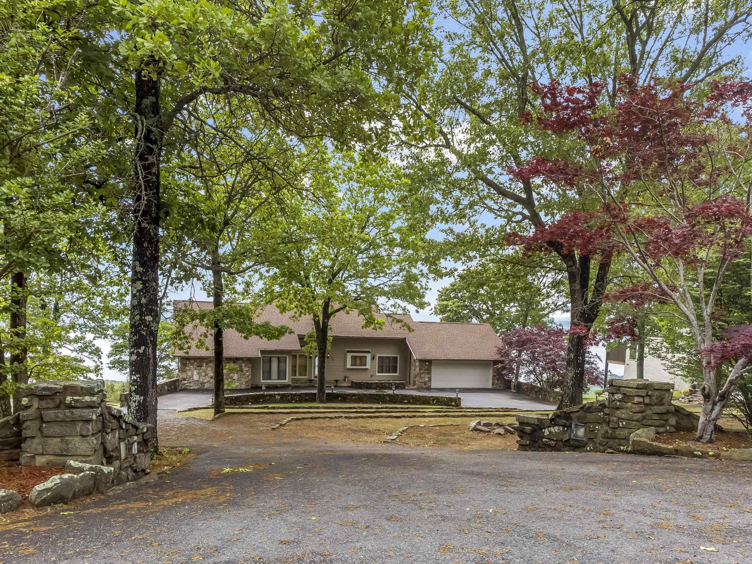 Breathtaking views of Greers Ferry Lake! Spanning over an acre, the lot features extra landscaping that blends seamlessly with the surrounding nature, creating a serene and private oasis. The home itself boasts a newly remodeled kitchen, new roof, new HVACS, panel for generator, porcelain tiled garage equipped with a sink and cabinets, in-ground Rainbird sprinklers, and views everywhere you look. Garage door and thermostat have Wi-Fi control capabilities. Mineral rights convey. Property is getting royalties. Outdoor living is elevated to new heights with two large decks offering stunning lake views, perfect for entertaining or quiet reflection. The presence of tons of wildlife adds to the allure, offering a front-row seat to nature's majesty. This property is not just a home, but a retreat from the everyday, a sanctuary where the wonders of nature meet the pinnacle of comfortable living. Be sure to check out the drone footage and 3D home tour. Make this lake view home yours today!