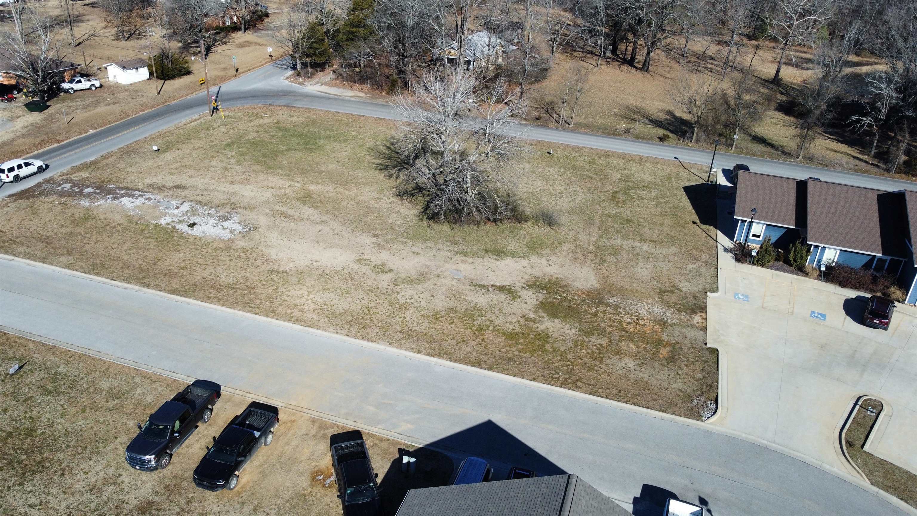 Great commercial lot with high visibility in a bustling commercial park!! There are three very well established businesses with lots of foot traffic and a built in customer base for your business. This lot has paved road access on 2 sides with one being a subdivision street on the south side and the road to Mountain View school running along the North side so no shortage of access on this one. All utilities are available on site to make the building process as easy as possible. See Plat in pictures for lot lines. Call today and lets go take a look!!