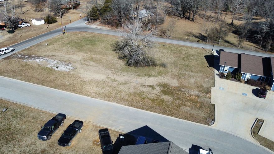 Great commercial lot with high visibility in a bustling commercial park!! There are three very well established businesses with lots of foot traffic and a built in customer base for your business. This lot has paved road access on 2 sides with one being a subdivision street on the south side and the road to Mountain View school running along the North side so no shortage of access on this one. All utilities are available on site to make the building process as easy as possible. See Plat in pictures for lot lines. Call today and lets go take a look!!
