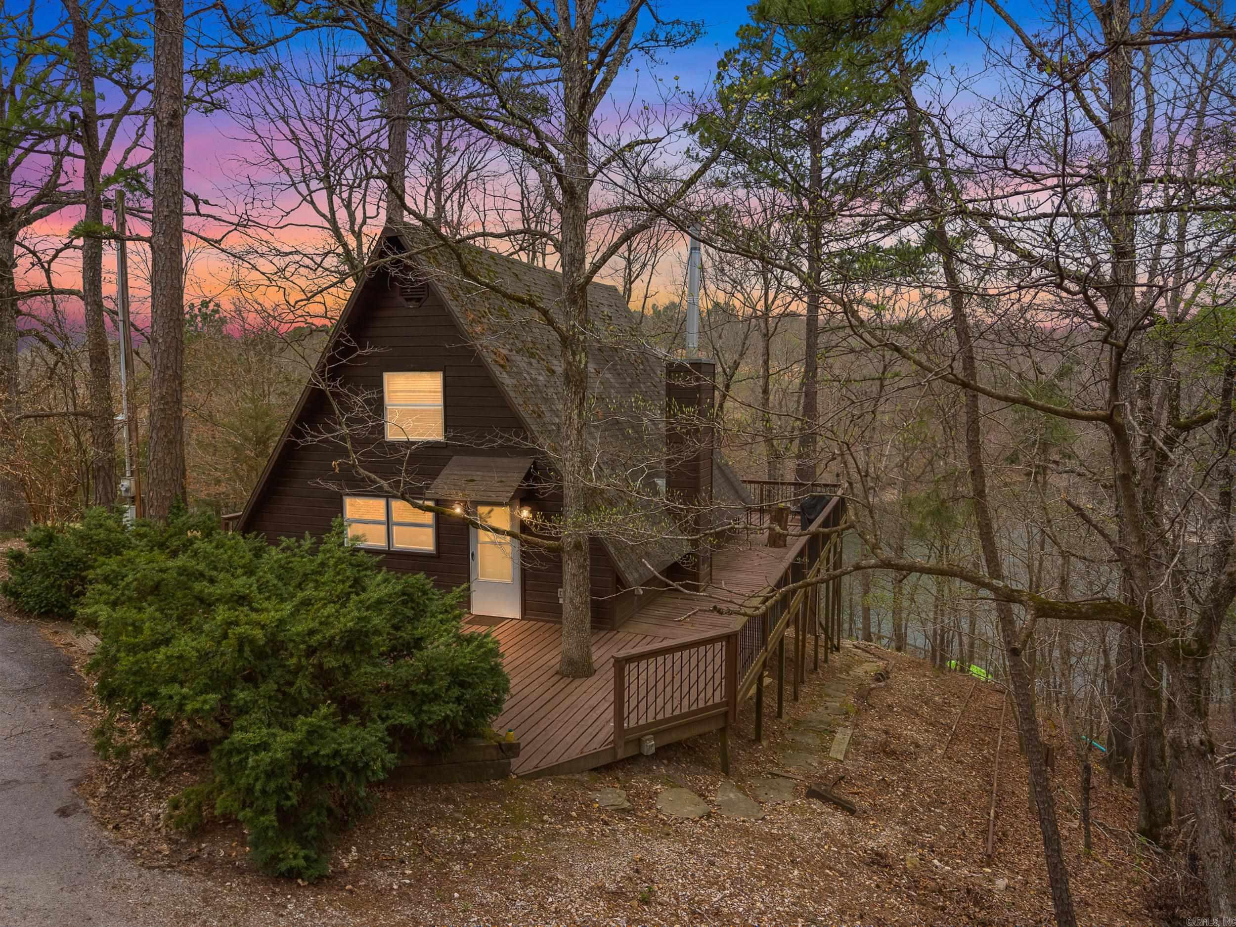 Charming lakefront property on the stunning Beaver Lake, tucked away in a peaceful, quiet area on 1.57 Acres! If you’re seeking tranquility and relaxation in a natural setting, this is the perfect spot. This home boasts 250 feet of shoreline, stunning lakefront views, and a short 75-foot walk to the water, where you can enjoy a cleared “beach” area perfect for swimming, fishing, or anchoring your boat. The home was remodeled about 8 years ago, with updates including a new blacktop driveway and Pex plumbing installed 3 years ago. And a new mini-split system and a septic pump-out were done in 2024. It was successfully run as an Airbnb/VRBO for 2.5 years and consistently stayed booked! VRBO Link here: https://www.vrbo.com/1963606 for access to reviews. Additionally, this property is available fully furnished. Schedule your showing today!