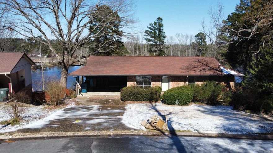 Lake Living in the City! This incredible home offers stunning outdoor space and decking right on Western Hills Lake. Featuring a unique split-to-the-rear design, it includes 3 bedrooms and 3 full baths. The open main living area flows into a bright breakfast room with breathtaking lake views. Start your day with coffee on the cozy screened-in porch. The primary suite boasts a sitting/dressing area, while downstairs offers a separate bedroom, full bath, and an additional living space with a fireplace. A rare gem in Little Rock—close to everything yet tucked away in a serene lakeside setting!