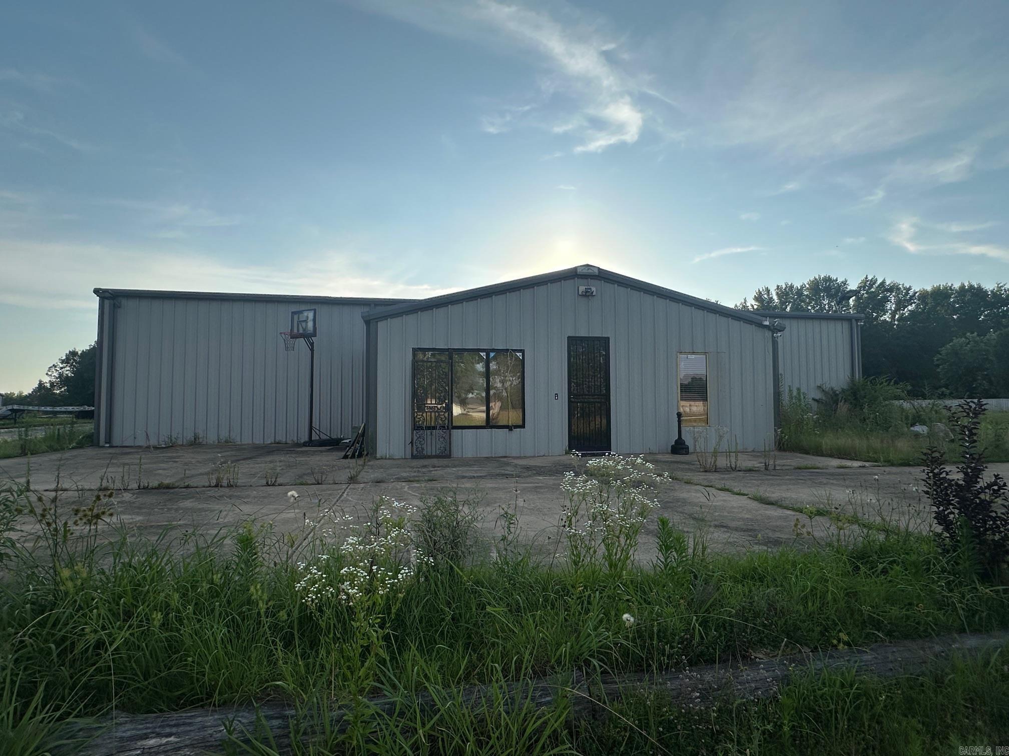 This large warehouse offers excellent functionality with 4 overhead doors, an office area, and a partially finished 400 sq ft loft—perfect for added storage. An additional 1,600 sq ft has been added to the original structure, providing even more room to grow your business or operations. Property is being sold as is, and some contents will be removed prior to closing. The owner was in the process of remodeling and was unable to finish. A great opportunity for investors, business owners, or anyone needing substantial space with convenient access. Contact today for details or to schedule a private showing! Sqft is approximate, please measure.