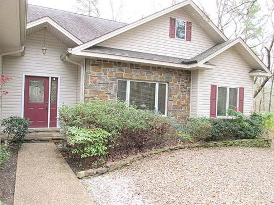 A Natural Beauty! Nature lovers relax and enjoy the beauty and serenity of this private woodland garden setting with flowering landscape, wet weather creek and natural wild life habitat. This one owner 3/2/2 custom home has quality throughout. Stark, vaulted ceilings, indirect lighting, custom cabinets, Pella Windows, Upscale Master Suite with Roman Bath and Walk in Shower & stunning Pine Arkansas Room /artist studio overlooking the woods Plus abundant storage & 936 sq. ft. workshop area under!