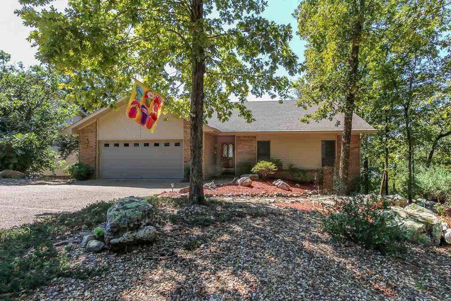 Comfortable & cozy yet plenty of room for friends & family. This 4-bed, 3-bath home offers a great layout w/3 bedrooms on the main level & in-quarters below. The main attraction is the beautiful MOUNTAIN & LAKE VIEW! Whether you’re entertaining or enjoying some quiet time, you’ll love the view from two large decks & Arkansas Room. This home is move-in ready with a newer HP, roof, & water heater; care-free vinyl siding, fresh interior paint, new light fixtures & dishwasher. Don't miss this must-see home!