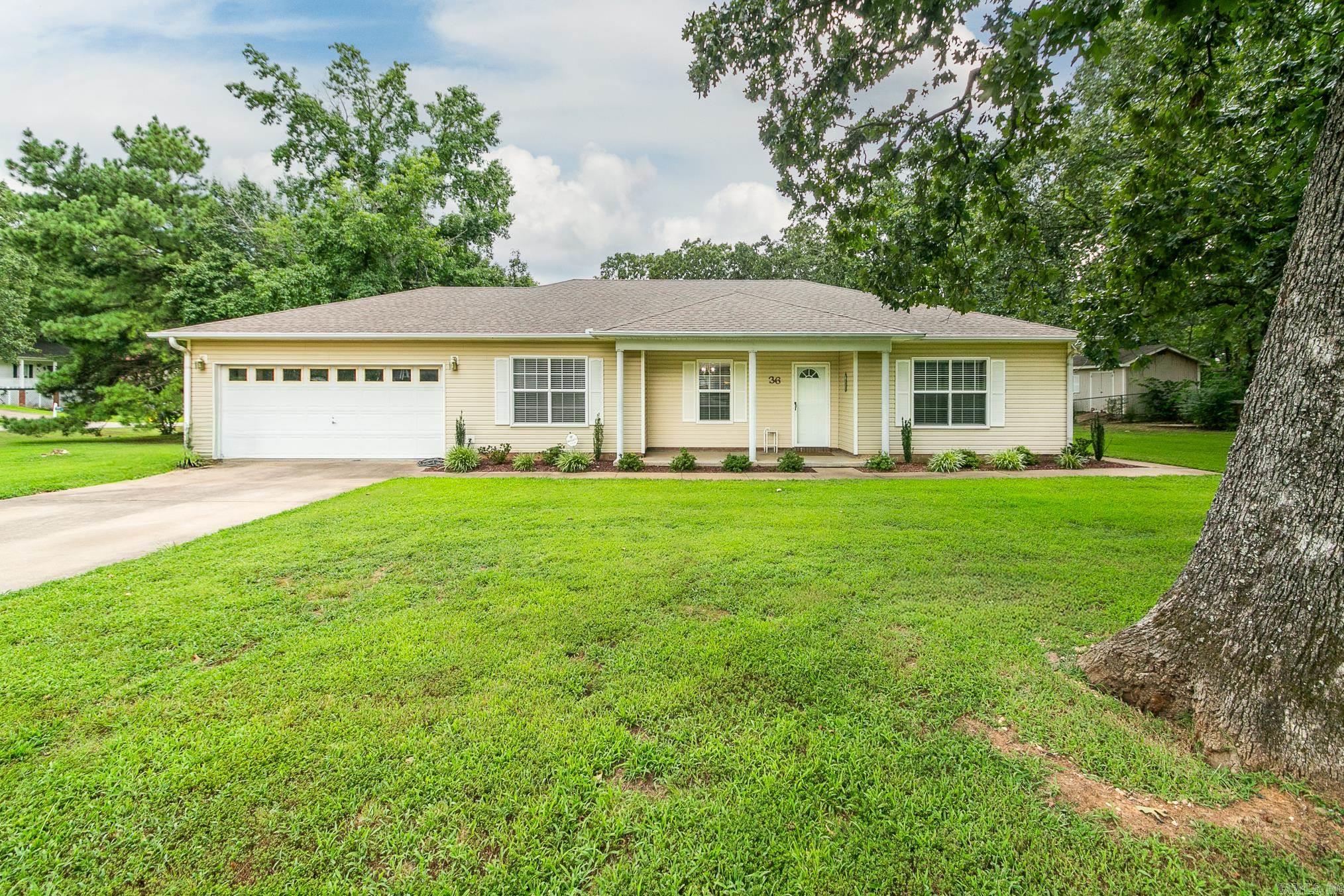 Well maintained, pretty house located close to amenities! This one level home offers 3 bedrooms, 2 baths, large living room with fireplace and tray ceiling. The kitchen and dining room are open, the kitchen has an island and breakfast bar, lots of counter-top space & plenty of cabinets. The primary bedroom is spacious with door leading to the deck. Primary bathroom has double sinks, 2 closets, tub and separate walk-in shower. Lots of windows to let the natural light in! Enjoy the fenced in back yard from the deck. Storage building stays! Nice corner lot with trees!