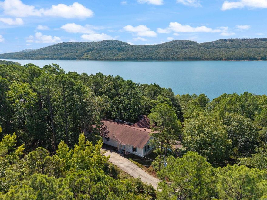 Welcome to your perfect lakefront retreat where comfort, space, and scenic beauty come together. This stunning home offers 4 bedrooms and 3 full baths, thoughtfully designed for both relaxation and entertaining. Step inside to discover a beautiful, oversized kitchen that truly serves as the heart of the home, featuring a massive stainless-steel island, ample counter space, and room to gather with family and friends. Just beyond, a bright and inviting sunroom provides the perfect spot to enjoy your morning coffee while taking in serene lake views. The property is made for fun and flexibility, boasting a dedicated game room complete with its own hot tub, shower, and restroom—ideal for hosting guests or unwinding after a day on the water. An additional bunkhouse that comfortably sleeps 6 offers even more space for visitors, making this home perfect for weekend getaways or extended stays. Outside, enjoy direct lakefront access with an easy walking path leading you right to the water’s edge. Whether you’re fishing, kayaking, or simply soaking in the view, this property delivers the ultimate lakeside lifestyle. Make this beautiful home and the unbeatable location yours today!
