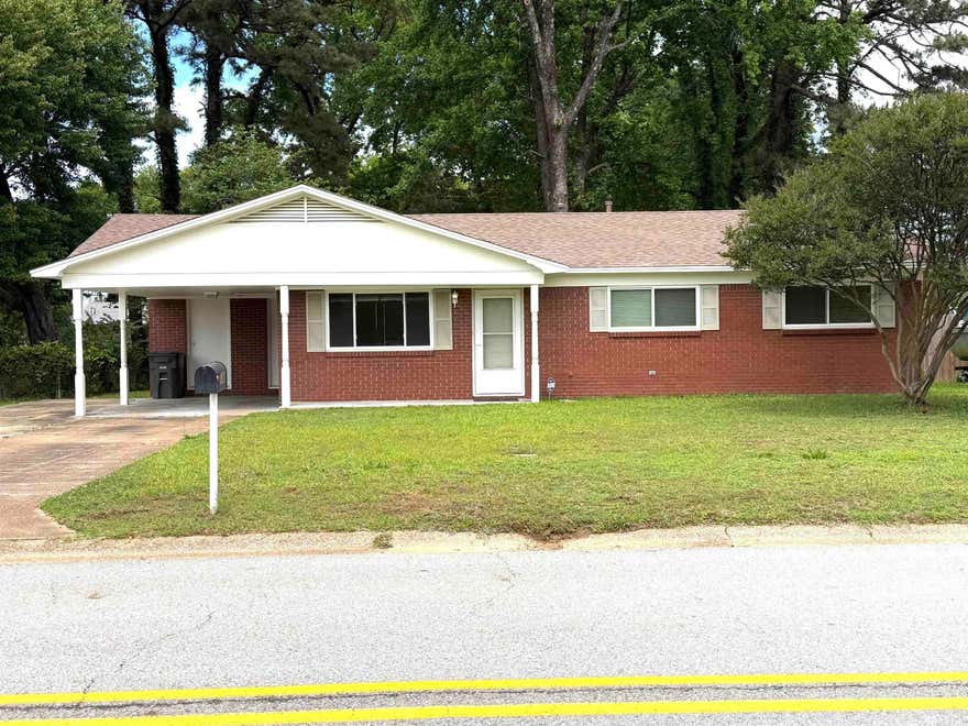 Discover charm in this well-maintained home! Enjoy new flooring, fresh paint, new windows and updated HVAC and roof for worry-free living. This home features paneling details which adds character. Spacious laundry.  Nestled on a large, tree-shaded lot, plenty of space to relax, garden or entertain outdoors. Conveniently located near elementary school and college. Come see what makes this home special! Call today for your tour.