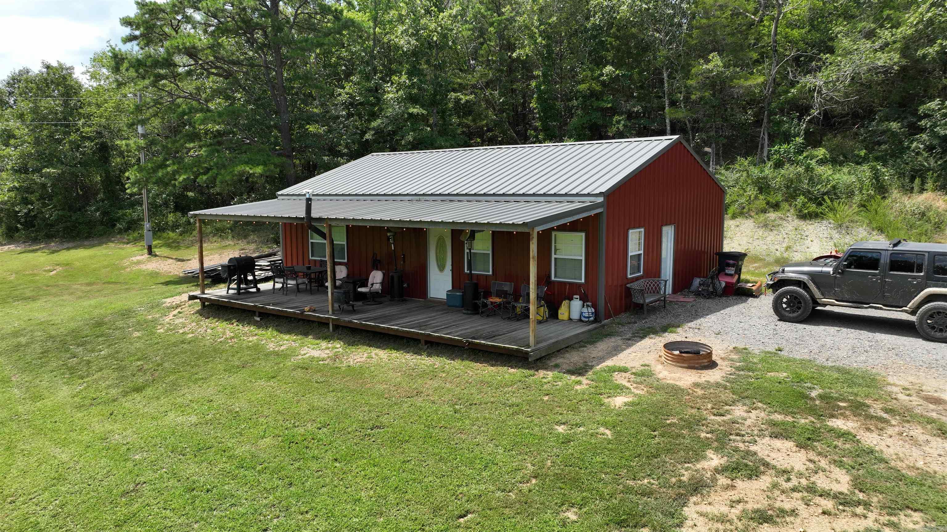 Escape to the perfect blend of rustic charm and modern living in this beautiful 2 bedroom, 2 bath barndominium-style home, built in 2021. Featuring an open-concept floor plan, this home is designed for both comfort and function, with central heat and air to keep you cozy year-round. Home needs some finishing. Step outside and take in the views from your full-length front porch, perfect for morning coffee or relaxing evenings. Nestled on 6.11 scenic acres with a creek, this property offers both peace and adventure. Home needs some finishing. Location, Location, Location! Just minutes from Mena, Arkansas. Close to Wolfpen Gap ATV Trails ā a paradise for outdoor enthusiasts. Highway frontage. Whether you're looking for a weekend retreat, a forever home, or a vacation rental investment, this property has it all.