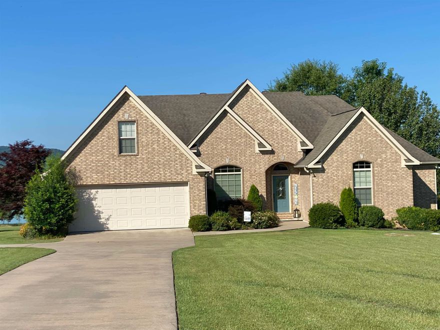 Come enjoys the views and gentle grassy walk to the water with this LAKEFRONT lakeview home!! Move-in ready, this home will have you experiencing the "lake life" and gorgeous sunsets in no time!  Centrally located on the Narrows in the gated Emerald Isle subdivision, it is less than 3 miles to Shiloh Marina and 4.2 miles to Lacey's Narrows Marina. Whether for vacation or full-time, this spacious home will accommodate all your friends and family, with additional storage for all your lake toys, side x side, and trailer, available under the deck.  New roof and new A/C in 2023!  Agents, please see Remarks.