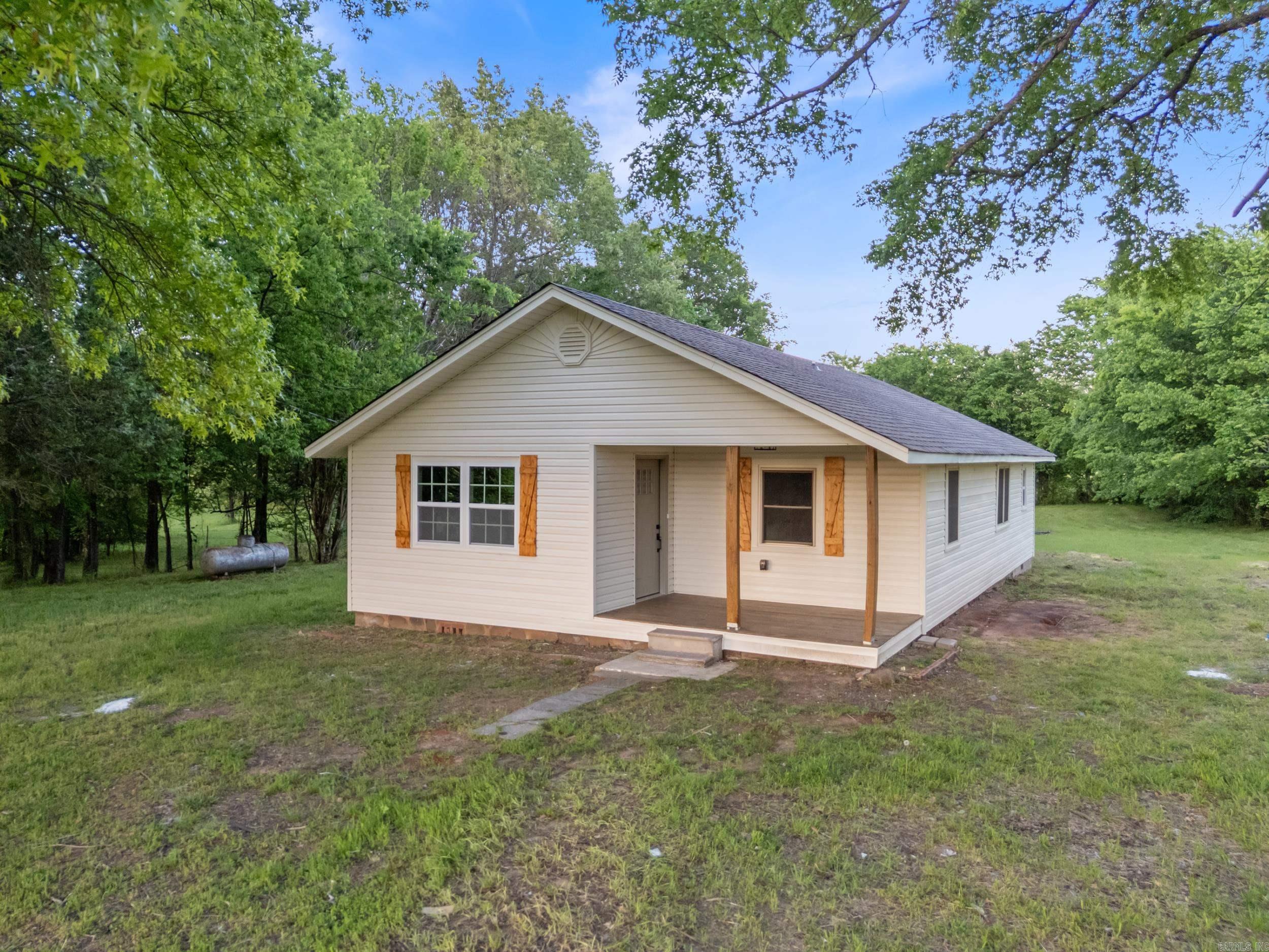 Have you been looking for the perfect country home, but all the ones you find need tons of updates? Look no further, this is it! Beautiful country setting with a home that has been completely renovated! The only things not new on this home are the exterior walls, footings, and windows. Everything else is new! Enjoy watching the sunset over the distant Ouachita Mountains from the inviting front porch. The home is surrounded by pastures and views of the rolling hills of the Ouachitas. Inside, you'll find an open floor plan with a living room that flows seamlessly into the kitchen. Granite countertops throughout this home. All new luxury vinyl floors, new paint, new fixtures, new doors, you get the idea! Importantly, the roof with architectural shingles is new as well. This could save you on money on insurance costs. Outside storage building that, with a little TLC, could be great for storage or a shop. This country home feels far away, but is less than 10 minutes to schools, shopping, and restaurants in the beautiful Ouachita Mountain community of Danville. Don't wait, schedule your private showing today!