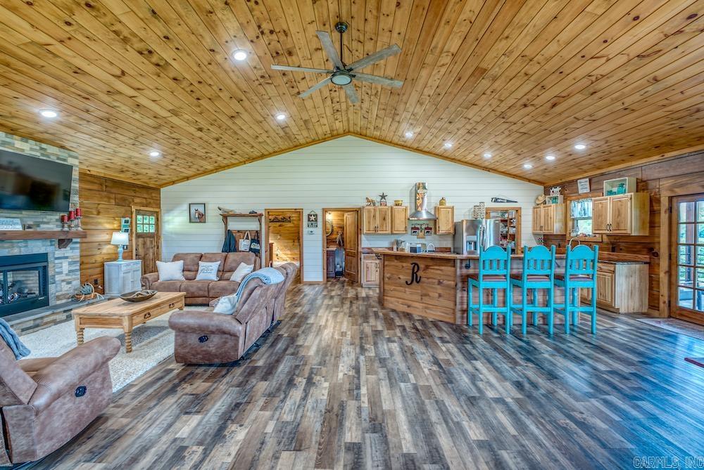 This immaculate custom log home and grass farm in the heart of the Ozark Mountains is the perfect blend of luxury, function, and natural beauty. The spacious home features vaulted ceilings, a stunning rock fireplace, custom vinyl plank flooring, and gorgeous shiplap walls. The kitchen boasts hickory cabinets, epoxy countertops, stainless appliances, a large bar, and two sinks. The main level also includes a powder room, laundry room, and a massive primary suite with granite vanity, oversized closet, and tiled shower. The fully finished basement adds two more bedrooms, a bathroom, large living area, and bonus room. Outside, a covered back deck overlooks panoramic mountain views and pristine pastures. The fully fenced and cross-fenced farm features multiple ponds, springs, a barn with corral, and live water creeks on three sides. Ideal for cattle, hay production, and top-tier hunting. Minutes from the Buffalo River and National Forest, this rare gem wonāt last long, schedule your private showing today!