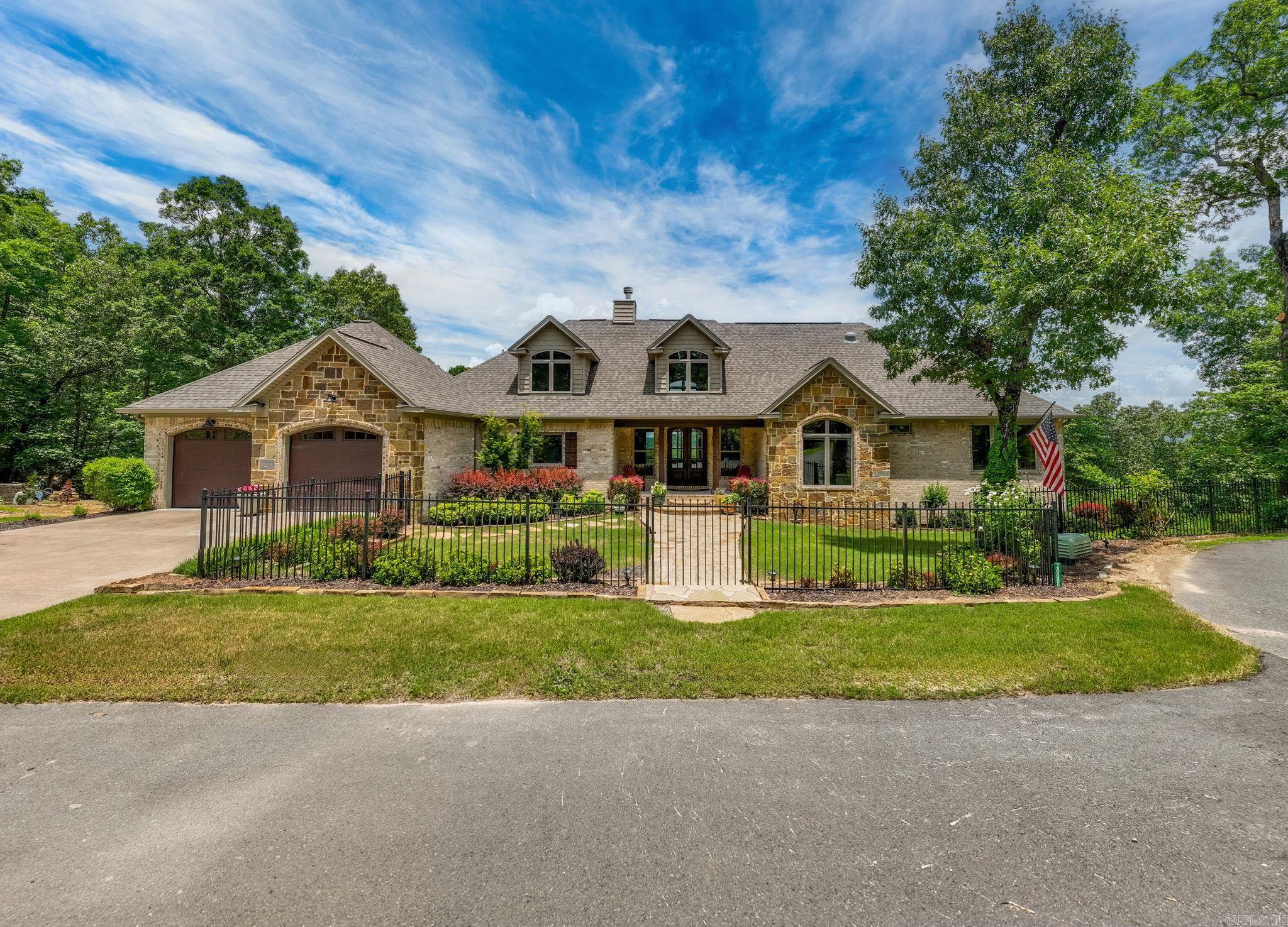 Experience breathtaking sunrises and serene privacy in this beautifully maintained home nestled on 5.25 acres of natural beauty. Located just minutes from Highway 10, this custom-built retreat offers luxury, comfort, and expansive views of Pinnacle Mountain. Featuring 3 bedrooms and 3 full bathrooms, with the potential to easily add a fourth bedroom, the home is thoughtfully designed for both everyday living and entertaining. The main level includes the spacious primary suite and a guest room, while the vaulted great room showcases large insulated windows that flood the space with natural light and offer panoramic views. The updated kitchen boasts an island, breakfast bar, and custom cabinetry for seamless organization and style. Downstairs, you’ll find the additional bedroom, a full bath, a generous game room, and ample walk-in storage. Enjoy the outdoors year-round with four covered porches overlooking the rolling hills and landscaped grounds. A whole-house generator ensures peace of mind, no matter the season. This property is a rare find and a true must-see!