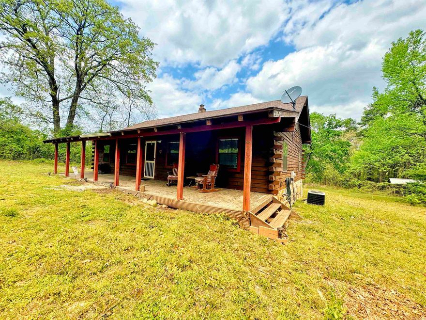 Are you searching for that adorable cabin that just demands some old wooden rocking chairs and a porch swing out front! Well here it is! Tucked back in the woods of the little community of Pleasant Grove, you'll find this quaint 4 bedroom, 2 bathroom cabin on 4.55 acres m/l. This country charmer has 3 bedrooms on the main level and an additional loft room accessible via stairs! On the other side of the home you'll find a pull down ladder to access the second loft space- think storage or hobby space! The sun room off the back is HUGE and offers a great view of your PRIVATE back yard! Many seem to be seeking a home with well water, and this one offers that too! The large yard offers plenty of space to set up the sweetest little homestead!