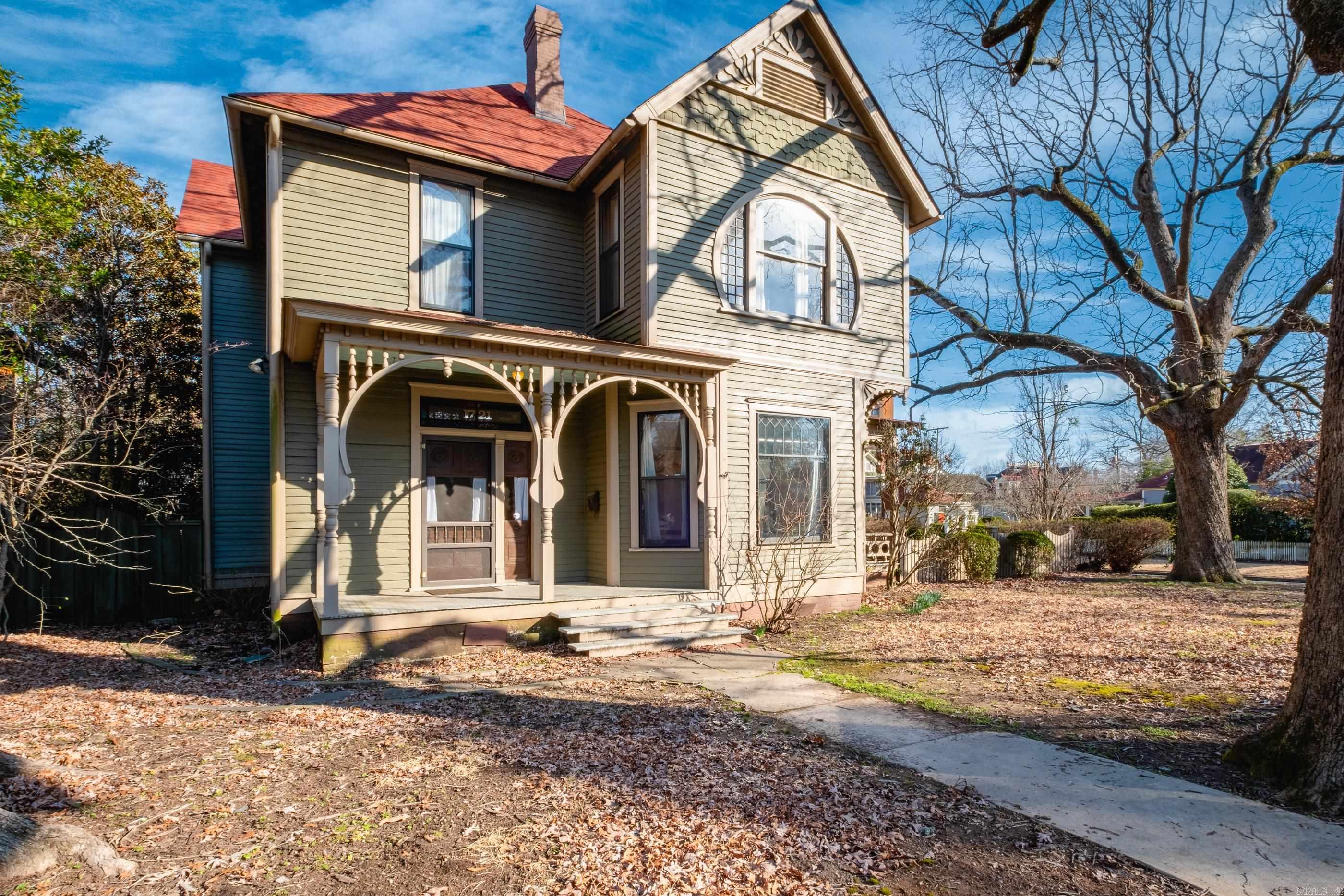 Located in the historic Quapaw Quarter, The Prather House is a beautifully restored home designed by architect Frank W. Gibb. This home blends historic charm with modern convenience, featuring a solid wood front door, a formal foyer with an impressive staircase, tall ceilings, and hardwood floors throughout. The spacious front parlor features a decorative fireplace and massive wood pocket doors that open to a second living area, which then leads to a formal dining room with leaded glass windows. The kitchen is well-appointed with a gas range, custom wood cabinetry, a pantry, and an adjoining sunroom/informal dining area. A modern office space and a half bath complete the main level. Three large bedrooms, two full baths, and a dedicated laundry room complete the second level with a second set of stairs down. Outdoor spaces include three porches (one screened), a brick patio, and a beautifully landscaped corner lot with iron fencing and a sliding gate. The detached two-car garage also features a potting shed as well as a 566 sq ft guest cottage with a full kitchen, bath and living area. A rare opportunity to own a well preserved piece of Little Rock history. Come see!