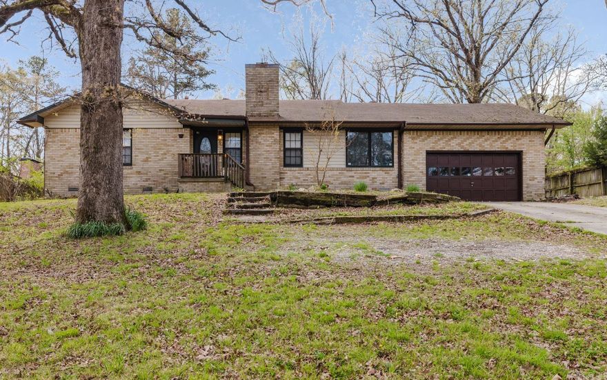 Charming 3 bedroom, 2 bathroom single story brick home just off Colonel Glenn offering character, functionality, and inviting indoor and outdoor living. The cozy living room features a fireplace and flows into a spacious eat-in kitchen with abundant cabinetry, generous counter space, gas range, and dining area. Unique ceiling details and natural light add warmth throughout. The primary suite and two additional bedrooms provide comfortable living options. Step outside to a large backyard retreat with a deck, covered patio, raised garden beds, and an expansive pavilion—perfect for entertaining or relaxing. Wooded surroundings offer added privacy. Additional features include a 2 car garage and established lot.
