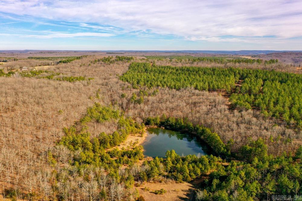Escape to the Ozark mountains to this fantastic multi-use recreational tract that is loaded with features in the perfect location. Situated just outside the rural community of Shirley, Arkansas sets a beautiful, and truly stunning tract of Ozark timberland with many opportunities. The property is fronted on two different sides by paved county roads. There is an incredible 2 +/- acre stocked, spring-fed lake that is beneficial for several recreation opportunities. As you make your way through the healthy stand of managed and thinned timber, you will find a quality stand of acorn-producing white oaks and red oaks, as well as large areas of 20 plus year old pines. This diversity leads to the immense amount of deer signs you will find as you cover the land. The gently rolling terrain provides no limits to the use.The region is loaded with deer and turkey, and with multiple access points combined with over 5 miles of roads and trails to access all of the property, this property sets up great for the hunter. Multiple massive oak-covered hills, pine forests, pinch points, and saddles just make this layout the ideal setup.
