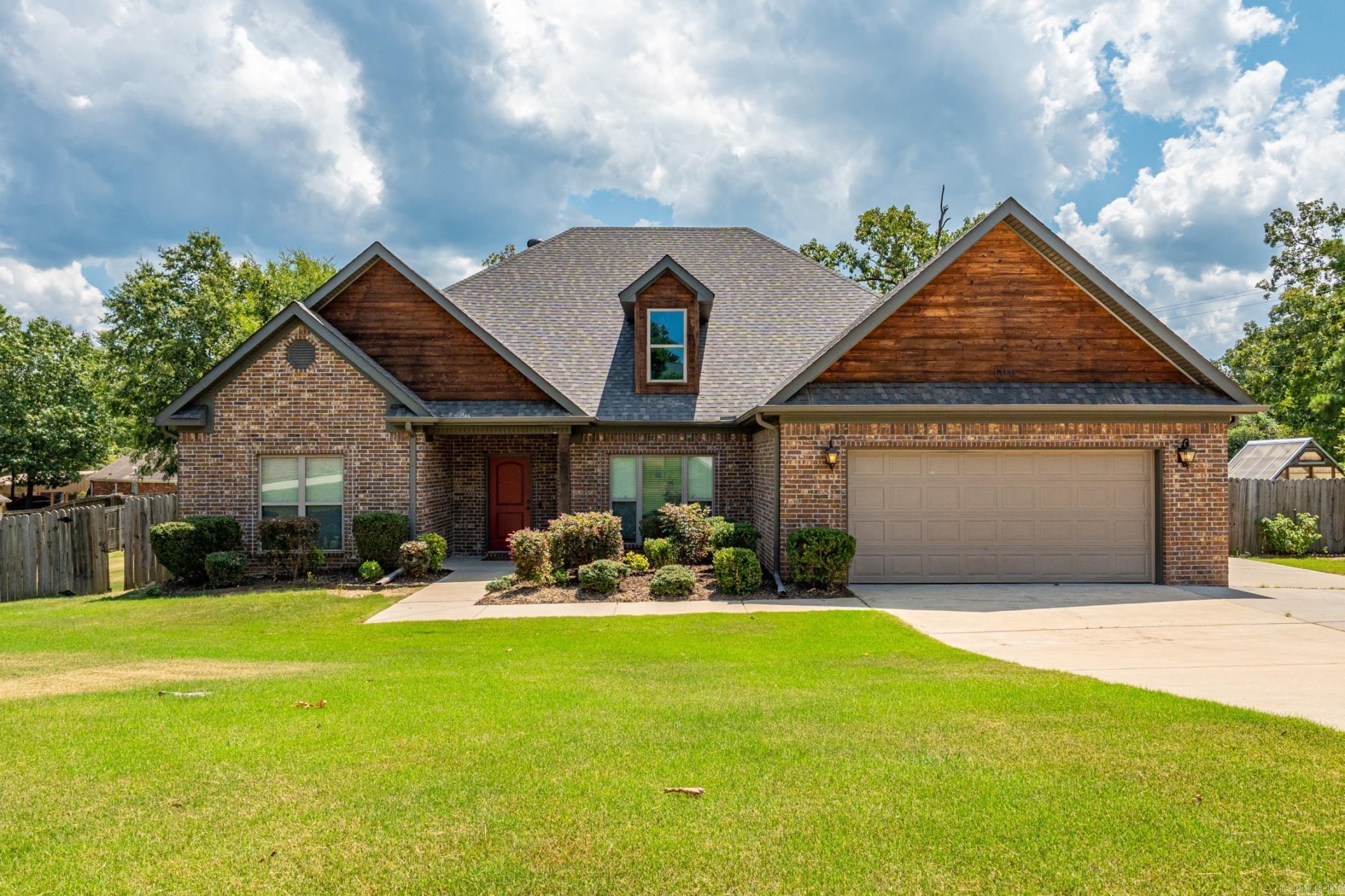Nestled in the quiet Hidden Forest subdivision, 109 Wild Dogwood Trail offers a peaceful retreat just minutes from Lake Hamilton, shopping, and dining. This thoughtfully designed home features an open, airy layout with natural light and a warm, welcoming feel. The spacious living area flows seamlessly into the kitchen and dining spaces, ideal for everyday comfort or entertaining. A dedicated office provides the perfect spot for remote work or creative projects, while the covered back patio invites you to unwind and enjoy the private, tree-lined backyard. The large master suite is a true retreat, complete with a well-appointed en suite bath and generous closet space. Whether you're relaxing indoors by the fireplace or enjoying the outdoors in the shade, this home offers a lifestyle of ease and tranquility. Located in the Lake Hamilton School District, this property combines privacy, convenience, and charm. Schedule your private showing to experience all it has to offer.