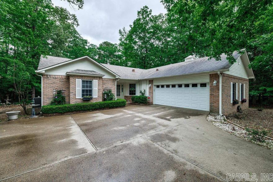 Immaculate Home located in the center of HSV.  3 BR 2 BA, Split Floor plan, Living Rm/Dining Rm Comb, Gas FP, Sun Rm w/Electric FP. off DR & MBR  MBR has His/Her Closets, MB has Double Sink Vanity, Walk-in shower, Jetted tub, Hardwood Floors in Living/Dining Rm, Sun Rm, Tile in BA, Kitchen & Laundry Rm. Carpet in BRs. 2 Car Garage, Roof 5 years old, HVAC 2017. Sit on you open Deck and enjoy the wildlife in the green space adjacent on one side and behind the house. All Appliances convey.  Refrigerator approx. 6 mths. old. Washer & Dryer convey, Hot Springs Village has a onetime buy in fee of $1,500 paid at closing.