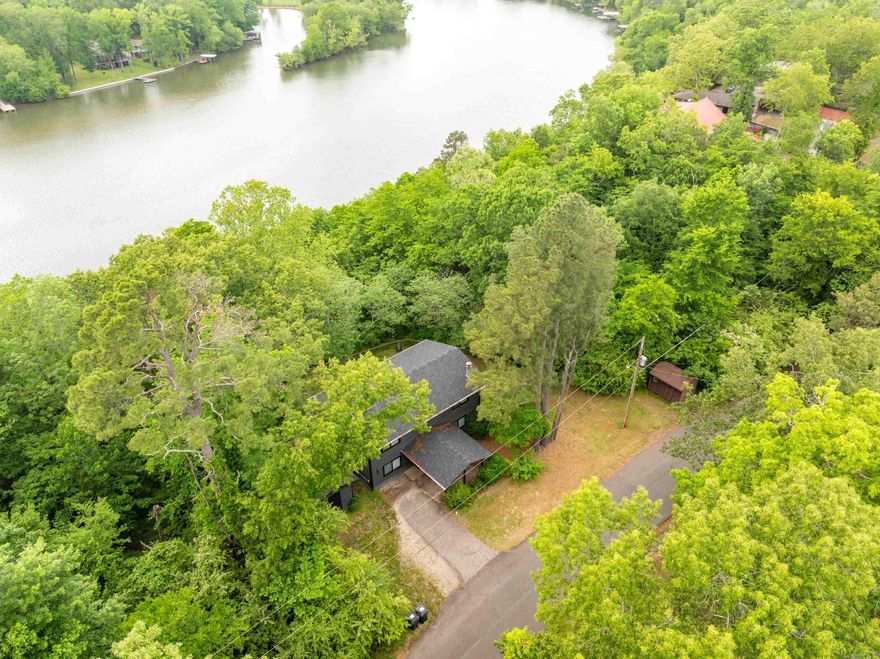 Completely remodeled lakefront home with a covered boat dock! Beautifully decorated and currently operating as a short-term rental, this property also makes an ideal full-time residence, vacation getaway, or investment opportunity. Enjoy serene surroundings, stunning views - especially in the fall and winter - and the peaceful fell of being nestled among the trees. This property can be purchased fully furnished with an acceptable offer. Call today to schedule your showing!