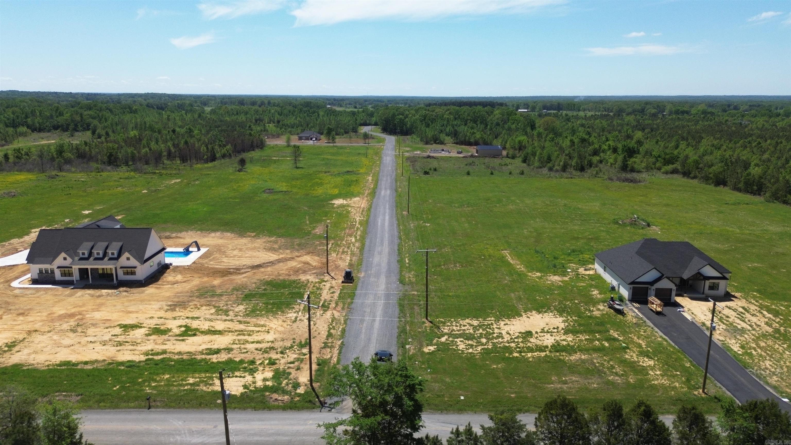 Beautiful flat 6.30+/- acre lot right outside of city limits, perfect spot if you are looking to build! Gorgeous new construction houses are going in all around. Enjoy great views of the countryside in a quiet area while only being a few minutes from the interstate. 20 mins to Vilonia, 20 mins to Searcy, & 20 mins to Cabot. Water and electric are available at the road. No mobile homes. Minimum square footage of 1700.