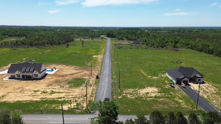 Beautiful flat 6.30+/- acre lot right outside of city limits, perfect spot if you are looking to build! Gorgeous new construction houses are going in all around. Enjoy great views of the countryside in a quiet area while only being a few minutes from the interstate. 20 mins to Vilonia, 20 mins to Searcy, & 20 mins to Cabot. Water and electric are available at the road. No mobile homes. Minimum square footage of 1700.