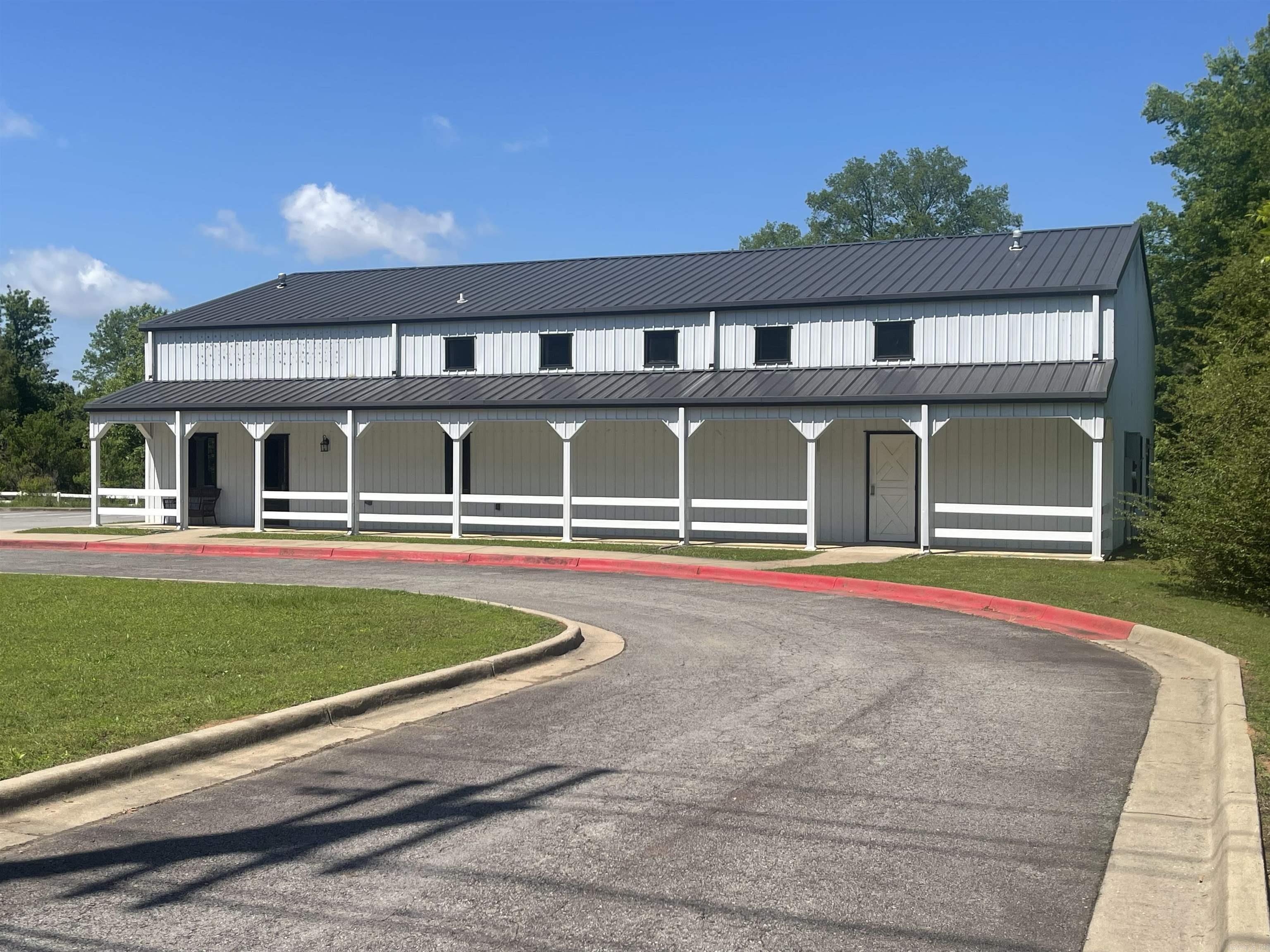 Multi-purpose building in a prime location. Only minutes to I-40 and shopping. It was most recently Ozark Mtn Trading Co, it would make a great event center, church, school or retail space. It has an unfinished loft area. It has a kitchen, 1 full bath and 2 1/2 baths. It's situated on 1.6 acres with a paved parking lot. Mixed-use floors.