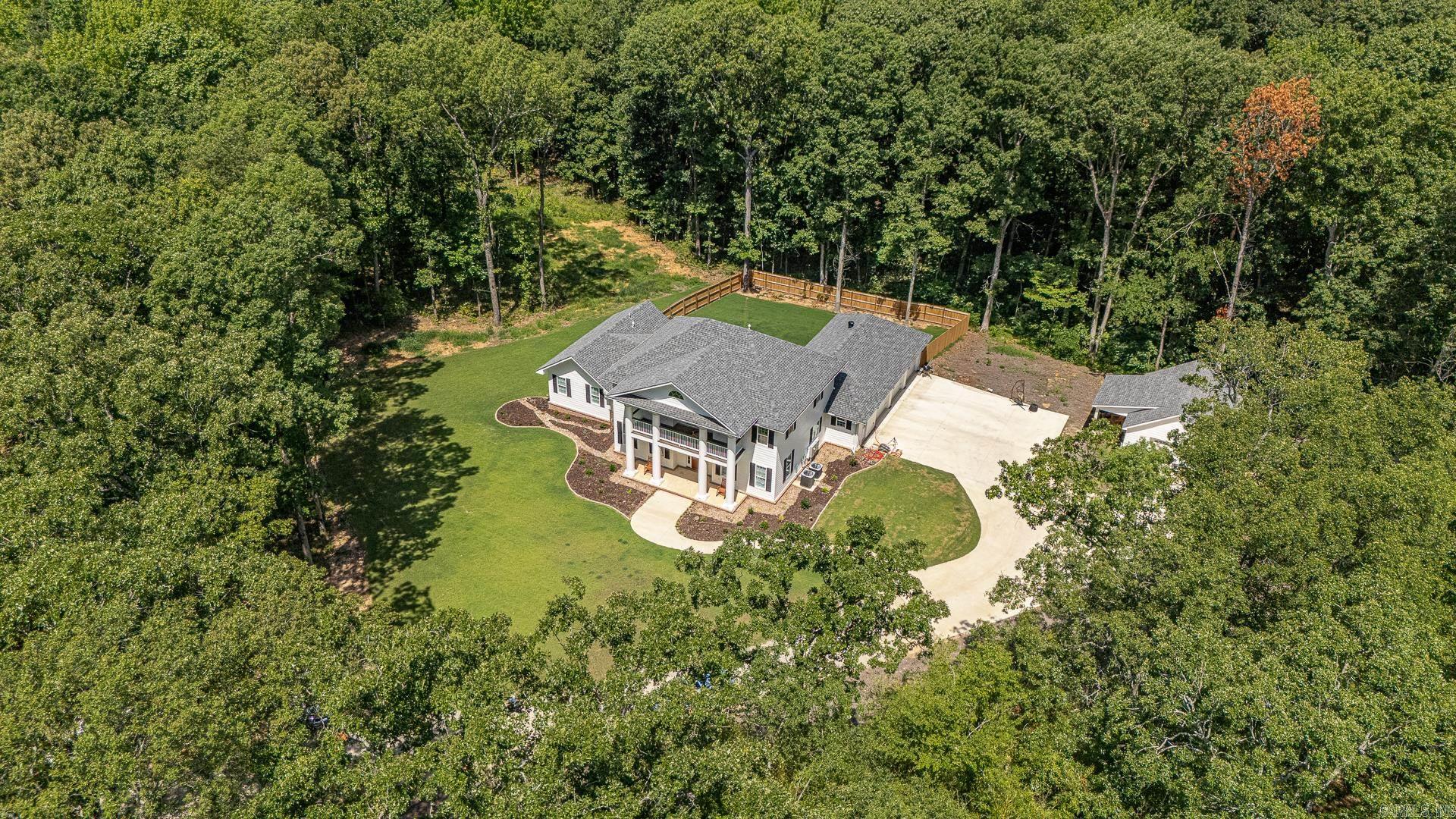 Nestled in the middle of a 6.6 acre wooded lot, this custom-built masterpiece provides the seclusion of a country setting while also offering all the amenities and access of living in the city. The construction, which was completed early in 2023, is a perfect blend of old, southern charm combined with the modern conveniences we all desire. At 3,270 square feet, this four bedroom, three and a half bathroom home in the Valley View School District is a must-see.