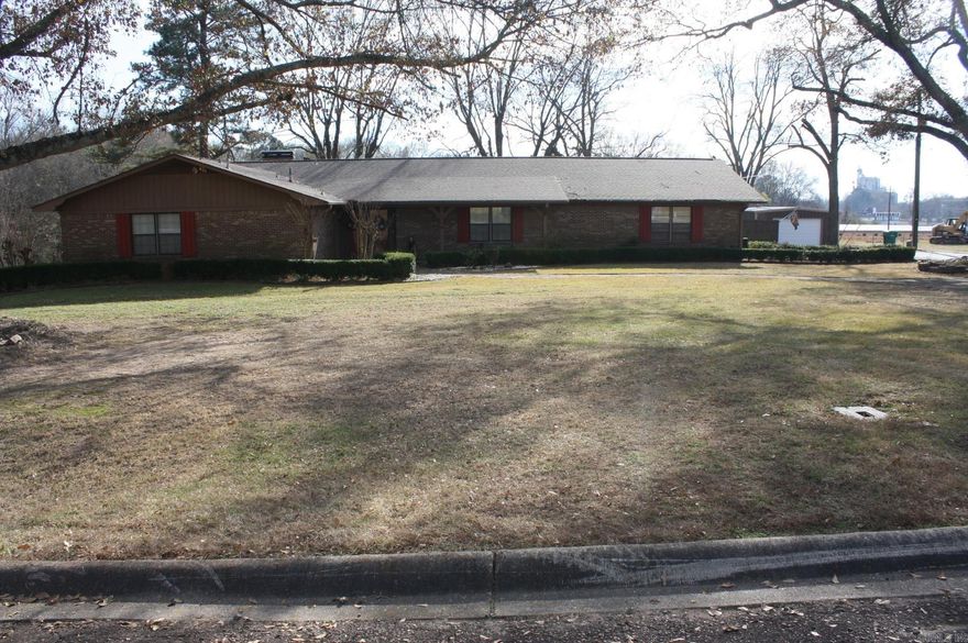 3 Bedroom, 2 Full Baths, approx. 3100 Sq. Ft. of living space.  Kitchen features lots of storage, 2 ovens, island with specious seating. Family area features massive brick wood burning fireplace and beamed vaulted ceilings.  Bath features updated granite walk in shower. Separate office space.  Large laundry area with spacious built-ins. Home also features a central vacuum system. Covered patio with views of landscaped yard.  Wood & chain link fencing. Auto lawn watering system includes garden area.  24x30 and 20x20 storage buildings.  Range-Ovens-Microwave, Refrigerator, Washer/Dryer and Drapes convey with sell of home.