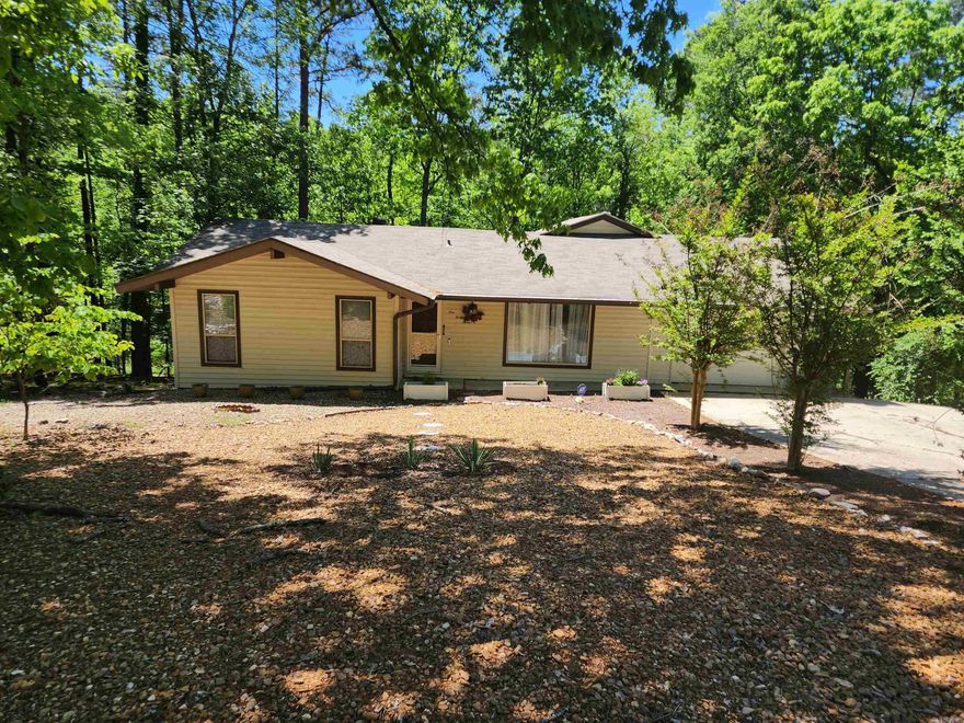 Welcome to your family's new home! The perfect blend of comfort, style and community, this updated home has it all! Luxury Vinyl floors, Marble countertops, tile backsplash; bathrooms are updated to the finest. Sunroom off the kitchen with additional room off sunroom. Also workshop or extra storage downstairs. Walk out from the bedroom or the sunroom into your deck and enjoy the tranquility, nature and tree's shades. Withing 10 minutes to the lakes, club house, restaurants and everything that Hot Spring Village has to offer. Don't miss on this one. Set your appointments today!