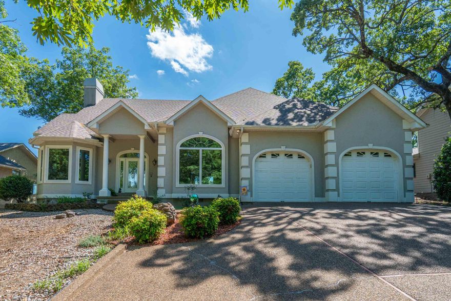 Experience the beauty of Hot Springs Village in this stunning mountain and lake view home designed to capture breathtaking scenery from nearly every room. Vaulted ceilings and fabulous windows fill the home with natural light while perfectly framing the panoramic views. The spacious covered deck is ideal for relaxing, entertaining, or enjoying peaceful mornings overlooking the water and mountains. Inside, the thoughtfully designed floor plan offers a separate dining room, generous living spaces, and a kitchen featuring abundant counter top space, extensive cabinetry, and a walk-in pantry for exceptional storage. The private main en suite provides a spa-like retreat with double sinks, jetted tub, separate shower, and dual closets. With 3 bedrooms plus a dedicated office, there is plenty of room for guests, remote work, or hobbies. The lower-level workshop offers additional functionality for projects, storage, or crafting. Located in beautiful Hot Springs Village, this home combines comfort, space, and unforgettable views with access to lakes, golf, trails, and all the amenities that make Village living so desirable. Call for private tour!