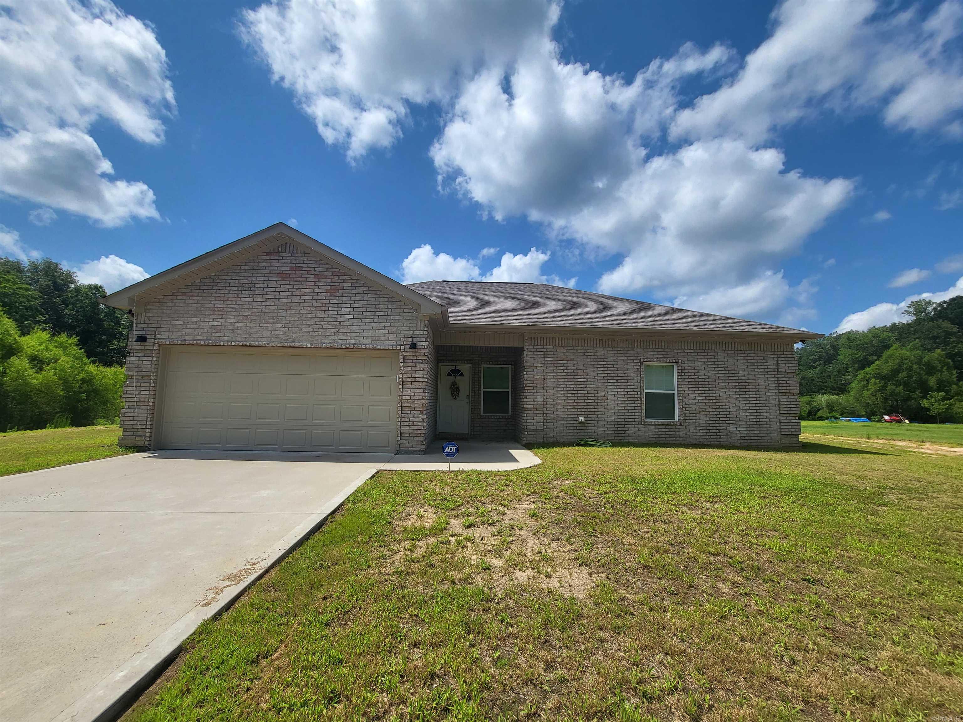 Don't want to inherit someone else's dirt? You won't have to in this pristinely kept 2022 build! It is clean as a whistle and ready for move in! If you're looking for some serenity in your life, this home sits in the middle of a full one acre lot on a quiet road with equally quiet neighbors. The split floor plan offers additional peace, with your own space away from moody teens or a visiting Uncle Eddie. The kitchen boasts granite countertops and fun hidden nooks 'n crannies for storage. A special added feature are custom interior shutters to help keep the Arkansas heat at bay. Cool fall nights will call you to retreat to your covered back patio for a bit of relaxation. Stop by today and see if this one is the right fit for you!