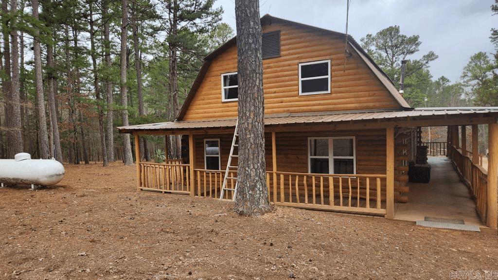4 bedroom 2 bath 1700 sq ft log home with 60 acres almost completely surrounded by Ouachita National Forest. No restrictions. Just 3 miles past the Montgomery County line on Hwy 8 (1.5 miles to Caney Creek entrance road and 0.2 miles to Big Fork Mall) at Big Fork is the road leading to this private/secluded property. Featuring plenty of trails and wildlife this is a must see. The log cabin itself has a large covered deck for enjoying outside along with a metal roof. There are 2 bedrooms downstairs with both baths and the 2 bedrooms upstairs have their own sitting area/office. Wood burning heater in the living room with a kindling box. All new windows around the home. The meandering creek is cold and runs year round. Couple of nice swimming holes, a picnic area, and pretty mountain views. Only 4 miles to Wolf Pen Gap. This could be the perfect quiet weekend getaway you are looking for, or it could be your retirement/forever space, or it could be the investment property you have been waiting for. 19 miles to Mena.