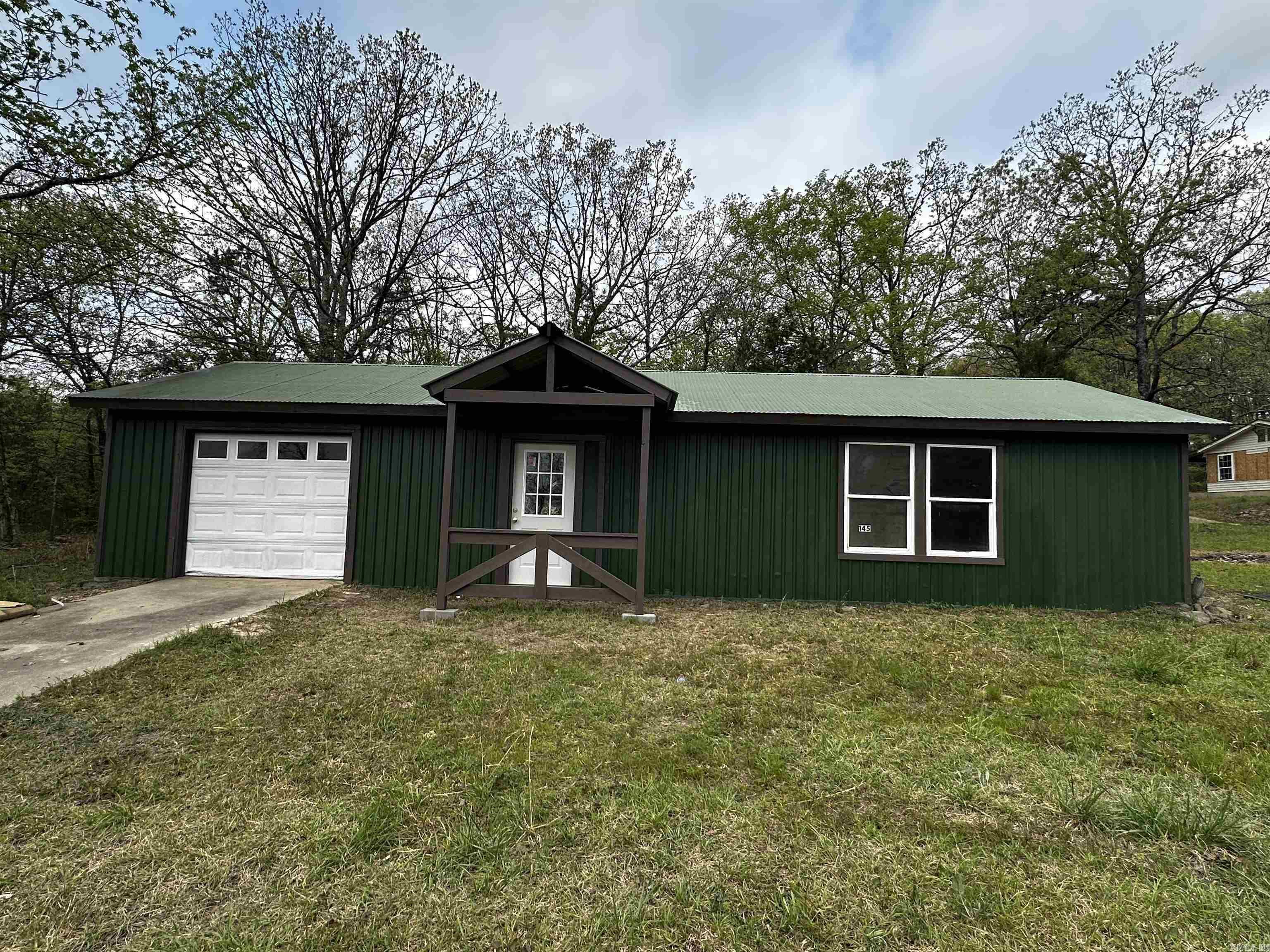 Take a look!! ONE ACRE with no restrictions AND a 20x50 Barndo-in-the-making on a concrete pad wired for electric with lights. NEW exterior paint with Porch added. Rural water is available at the road. NEW SURVEY! The building is ready for you to make your own! Park your RV and enjoy everything Mena has to offer! 2 miles to Lake Wilhelmina, a few miles to National Forest and Bike Trails!