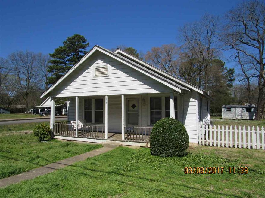 New carpet and freshly painted throughout, gas/range oven, spacious bedrooms, shower in master bath, large laundry room/office area, covered front and rear porch, detached storage building.