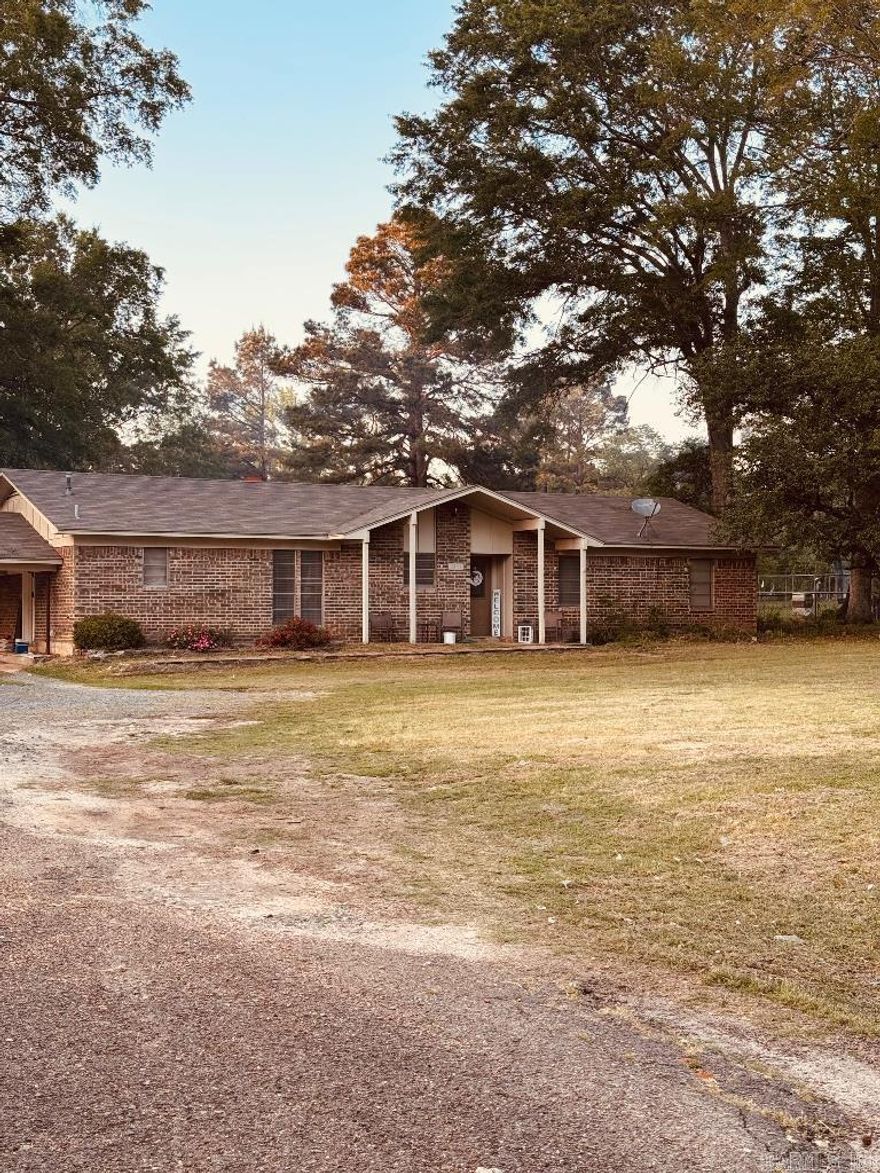 This charming single family home is perfect starter home. Featuring 3 bedrooms and 2 bathrooms with an office/ workspace. The spacious yard offers just what you need for  gatherings or to just plant a garden. Small storage shed on the property. This place is on Arkansas side outside of the city limits. In just 10 minutes you can be anywhere in town. This home sits just under 1 acre at .83 Acres just outside the city limits.