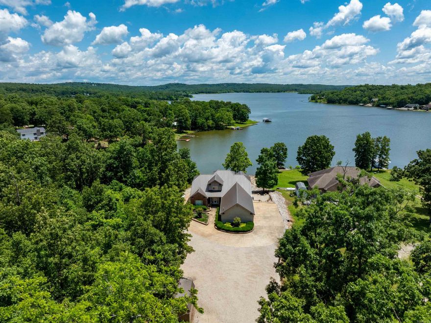 Stunning Waterfront Home on Crown Lake – 4,200± Sq Ft, Move-In Ready!  This beautiful 3 bed, 3 bath custom-built lakefront home offers approx. 2,100± sq ft on the main level and 2,100± sq ft finished walk-out basement—perfect for full-time living or a lake retreat. Enjoy panoramic Crown Lake views from soaring living room windows, vaulted ceilings, and a cozy fireplace. The kitchen features bar seating, a dining nook, and opens to a screened-in porch overlooking the lake.  The main level includes an office or formal dining room(which ever a person decides to use it for), guest bedroom, full bath, and a spacious primary suite with bay windows, double closets, and ensuite bath. A large laundry/pantry leads to a covered carport and 3-car garage.  Downstairs offers a massive rec room, bedroom, bath, kitchenette, and two oversized craft rooms—one ideal for a theater. Step outside to a covered patio, private boat dock, fire pit area, and low-maintenance landscaping.  Bonus: Seller added a new furnace and heat pump in 2023. Located in peaceful Horseshoe Bend, AR, near golf, trails, and three lakes.  Ready to move in and enjoy lake life!