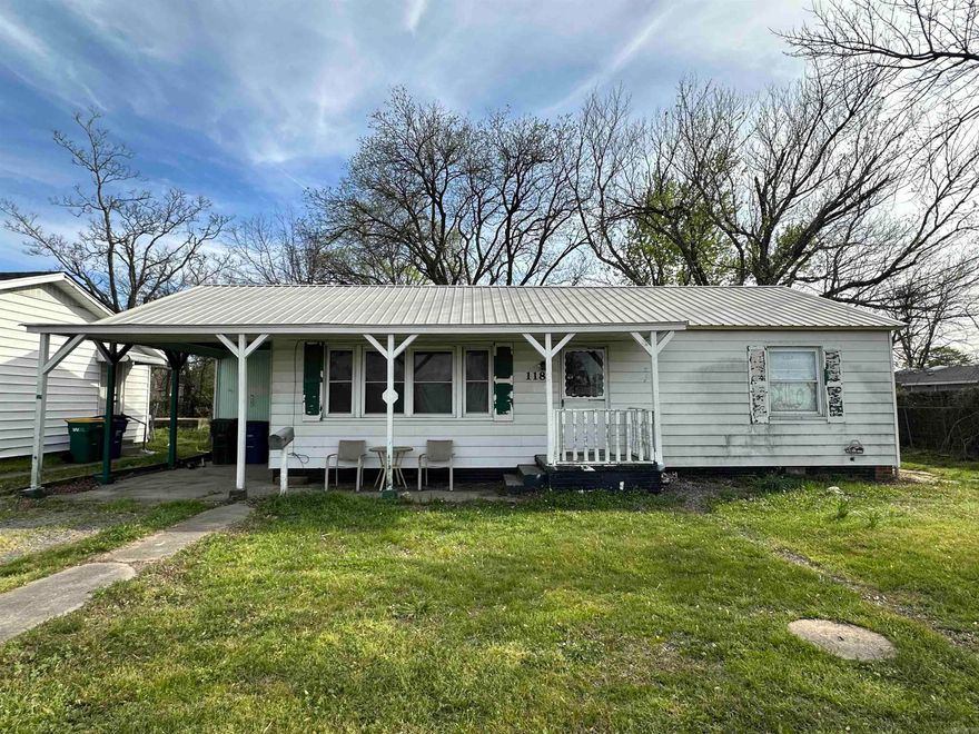 Ideal property for an investor flip or an owner remodel, near shopping and I40 access. Home has good bones with a NEW metal roof placed in 2023. Windows are decent and are not the original, only back window glass will need replaced (no water intrusion). NEW wiring was updated about 10 years ago, has some new receptacles placed throughout the home recently. Kitchen area is ready for new cabinets with NEW painted drywall, NEW plumbing, sink and NEW garbage disposal, needs flooring. Flooring in the rest of the home is restorable condition, is the original hardwood flooring, needs refinished but in decent shape. The dining area flooring possibly also could be restored. Hot water tank was NEW 2024/25. The bathroom needs some TLC. HVAC system is working.  Spacious backyard has a large cement pad with a metal shed and chainlink fencing is complete with side gate. French drain has been put in front yard, drains to street. This home will go fast, does not need totally gutted, book your appointment today.