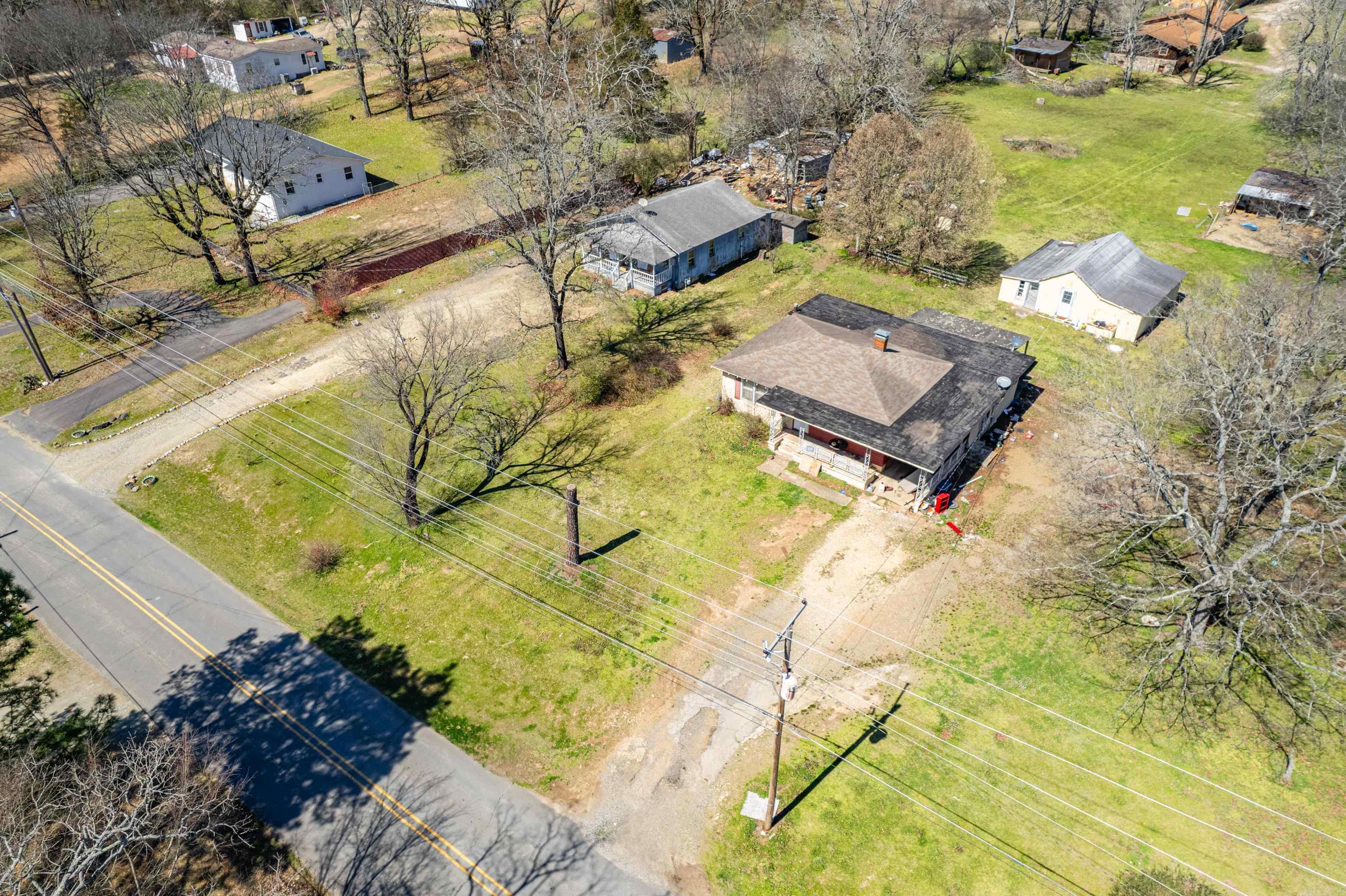 THIS LISTING INCLUDES ADJOINING LOT AND HOUSE AT 130 SOUTH PEPRSIMMON & 2737 SPRING STREET with a total of 3.03 acres. This property is next to Cutter Morning Star and is visual from the bypass. It's in the county and can be used for residential or commercial. The home on Persimmon is the larger of the two homes and the blue house is on Spring Street.