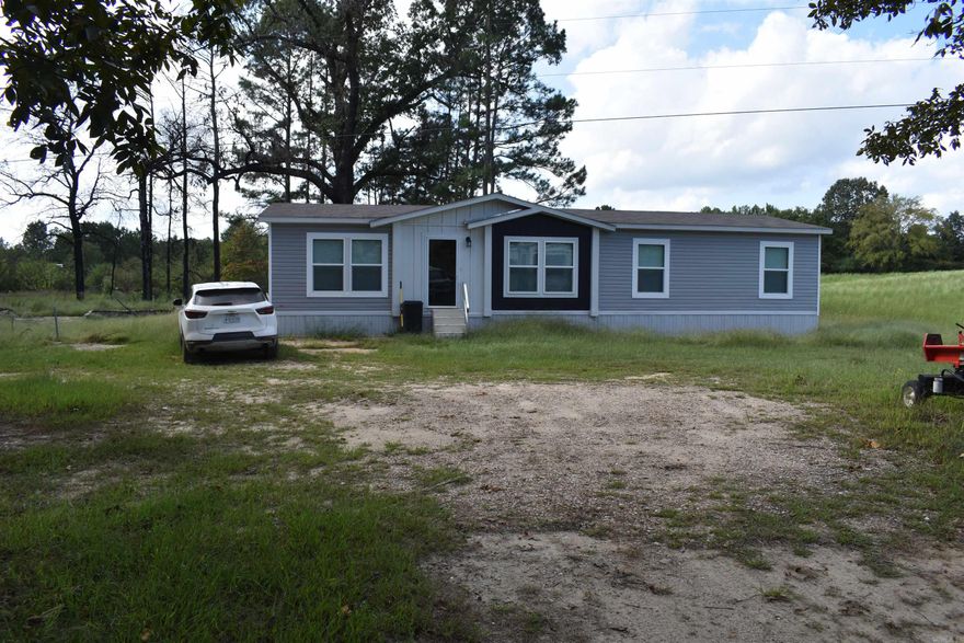 Located just outside of Grannis in southern Polk County, this 40 +/- acre homestead has multiple features that set it apart from other tracts in the area! The acreage is located at the end of a dead-end road, and has a nice buffer of timber around all of its boundaries, providing unparalleled privacy. Towards the southern end of the property a brand new three bed two bath mobile home sits on a nice knoll overlooking a spacious meadow. The mobile home is nicely finished with several upgrades, and is less than a year old. Just down the hill from the home, through a grove of mature oak trees, the 50’x100’ five bay shop allows ample space for many projects, or even the potential for a work from home business.  • 40 +/- Acres • New 3 Bed 2 Bath Double Wide Mobile Home • 50x100 Five Bay Automotive Shop • Five Ponds • Private and Secluded Setting • End of Dead-end Road • Less than one mile from Highway 71 • Older Home with outbuildings • Huge old growth Oak trees • Multiple homesites • Excellent access Via Kare Lane and South Eaton Rd • Perfect layout for Family compound or multiple cabins • Great deer hunting • Excellent topography