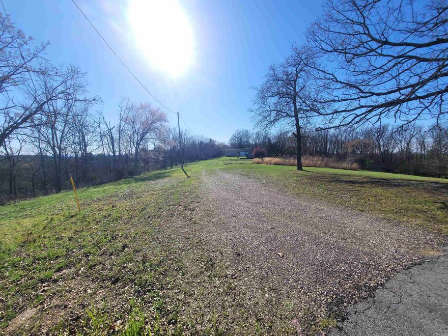 6.02 acres,  2 acres cleared, with fill- dirt on site ready for building. The property formally had a house on it.   4.04 acres are wooded acres. Top of the hill great view of mountains, to the South. quiet secluded acreage. well water available, has public water. septic system, electricity.  (1)  12x26 site built, storage building with lean-to , also 30x40 metal shop with electricity, shop is on a concrete slab. Currently does not have living quarters.