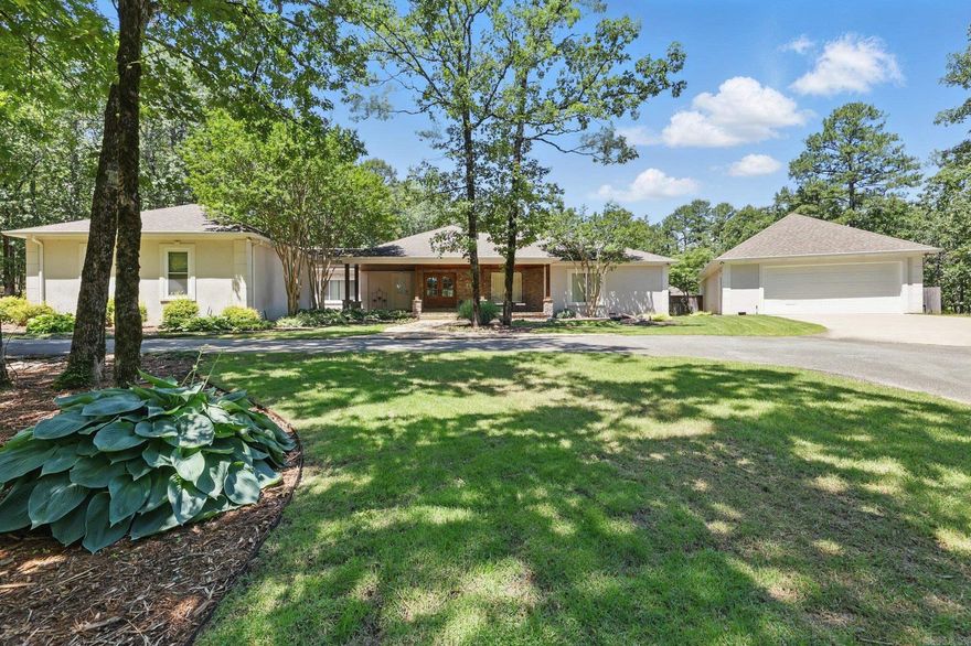 The main house, fully renovated in 2017, boasts 3,400 SF, featuring 4 bedrooms & 2.5 baths. The open floor plan showcases hickory wood floors & a chef's kitchen equipped w/ top tier appliances, including a built-in double refrigerator. The spacious master suite offers a relaxation corner & a secure safe room accessible from one of the closets. It includes his-and-hers closets and sinks w/ a makeup bar, along w/ a walk-in shower featuring 8-foot glass walls & a freestanding soaking tub. The laundry room is well-appointed w/ ample storage, lockers, & a sink.  Stepping outside, you'll be enveloped by a forest setting & an expansive flagstone terrace that leads to the pool area. The exclusive 2-bedroom, 2-bathroom guest house includes a kitchen, laundry, and open living space. The property also features a standard 2-car garage & an additional detached tandem garage, which includes a storage room/workshop and a stairwell to a second-level storage area. The crawl space is professionally wrapped for protection. This home is equipped with a comprehensive media system featuring indoor & outdoor audio & video capabilities. The compound is gated w/ iron fencing, ensuring privacy & security.