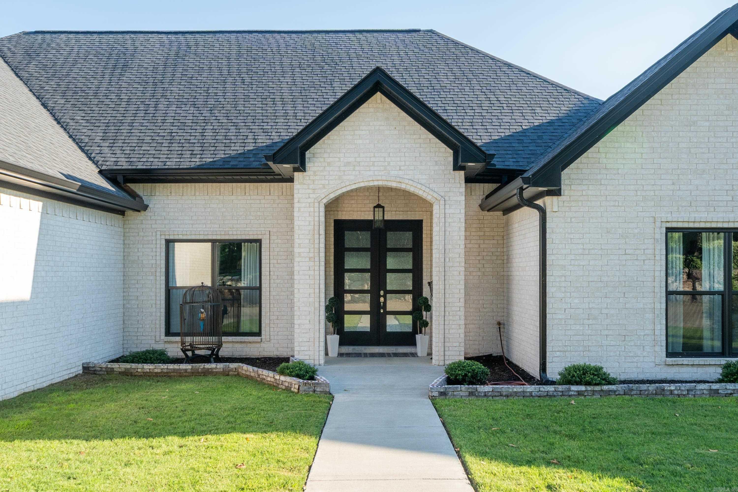 This beautiful 4 bedroom 2.5 bath home takes full advantage of the gorgeous views overlooking a wide channel on Lake Hamilton. It is located in a gated community with access to a pool and cabana area. The large Main bedroom features an en suite with oversized his and hers closets, a stand alone tub, walk in shower and duel vanities. The main bath conveniently connects to the laundry room. This home has an open floor plan with wonderful custom kitchen with lots of storage and a walk in pantry. The family room is spacious and has an electric fireplace and lots of windows highlighting the views of the lake. The other 3 bedrooms and bathrooms share a separate wing for privacy. Outside you will find a large covered back porch with an outdoor kitchen area, a boardwalk and a boat slip.