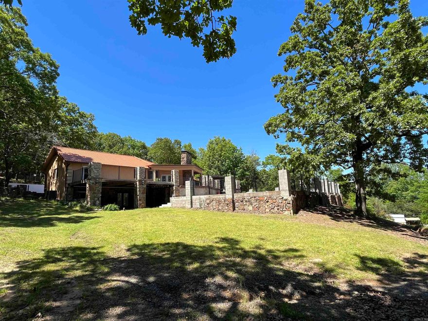 LOCATION! If being in the right spot is what you're after, don't miss out on this beautiful home. It sits about 10 minutes from downtown Russellville, about 2.5 miles away from Interstate 40 access, and less than a mile away from Arkansas Nuclear One! This home is also extremely close to beautiful Lake Dardanelle. You can catch glimpses of it through the leaves. Plenty of space for entertaining with a 1,300+ square foot attached garage, and a giant back deck / patio. The large in ground pool over looking the front yard is the perfect spot to hang out and beat the heat. With a few finishing touches, you could make this house your forever home!